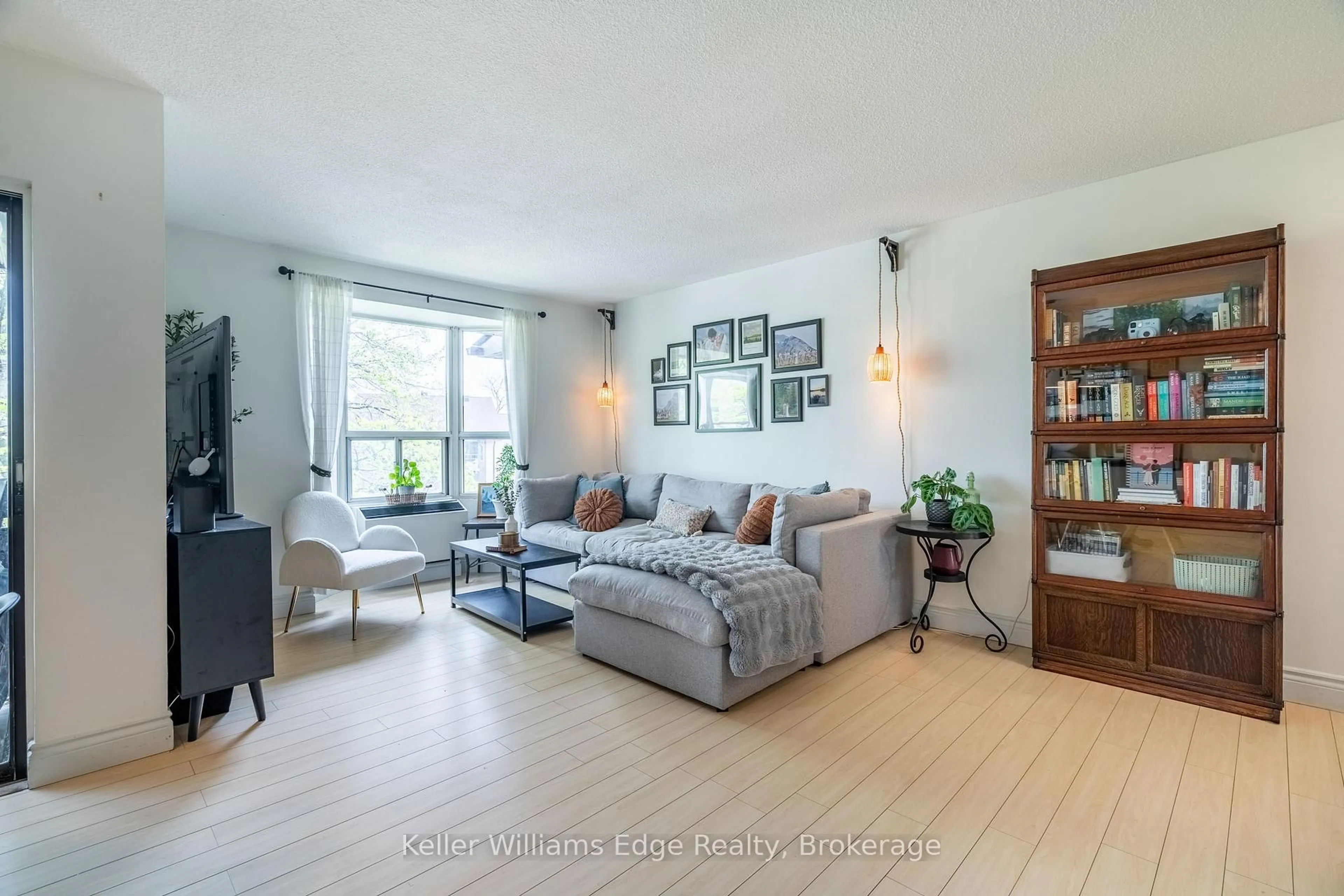 Living room with furniture, wood/laminate floor for 3835 Lake Shore Blvd #305, Toronto Ontario M8W 1R2