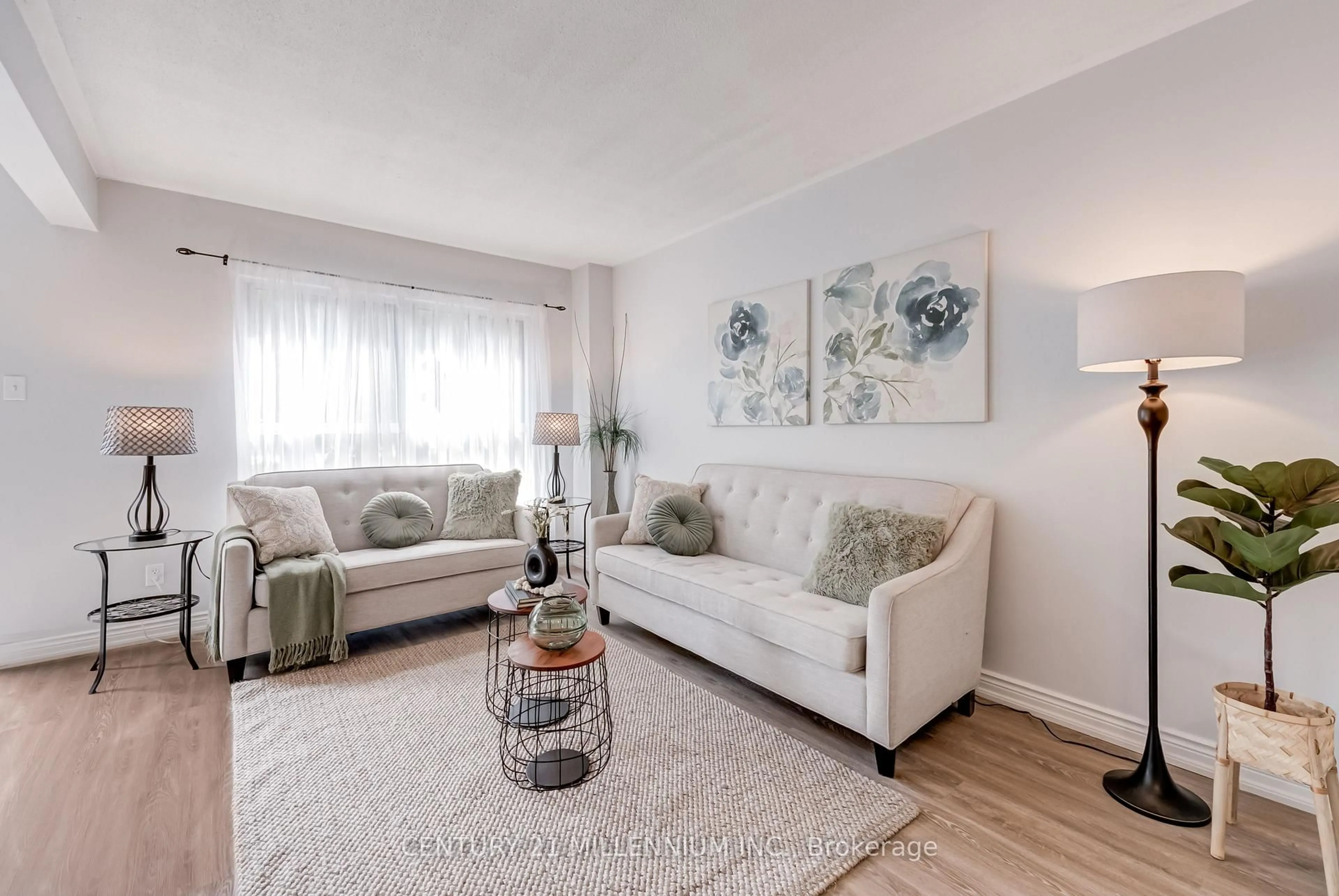 Living room with furniture, wood/laminate floor for 56 Fleetwood Cres, Brampton Ontario L6T 2E5