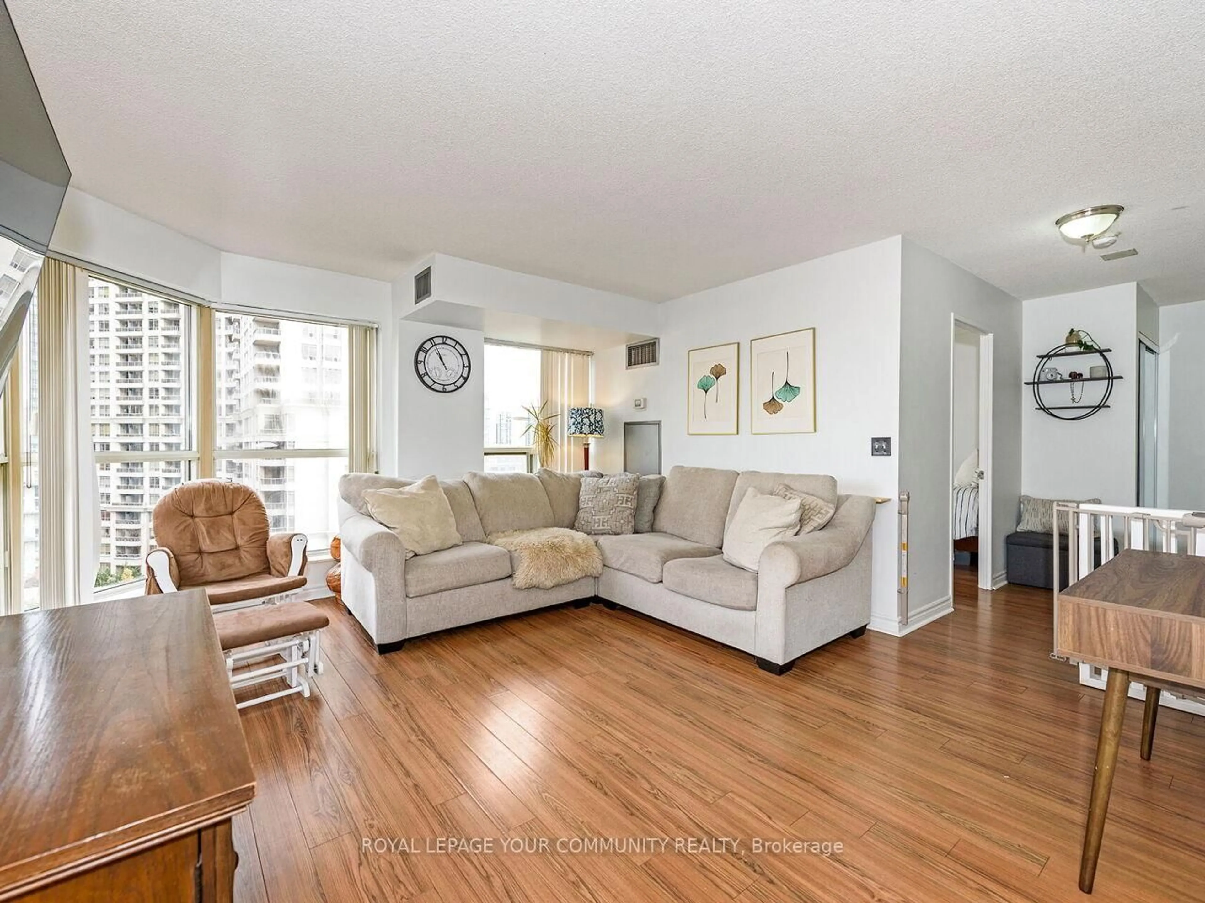 Living room with furniture, wood/laminate floor for 325 Webb Dr #1109, Mississauga Ontario L5B 3Z9