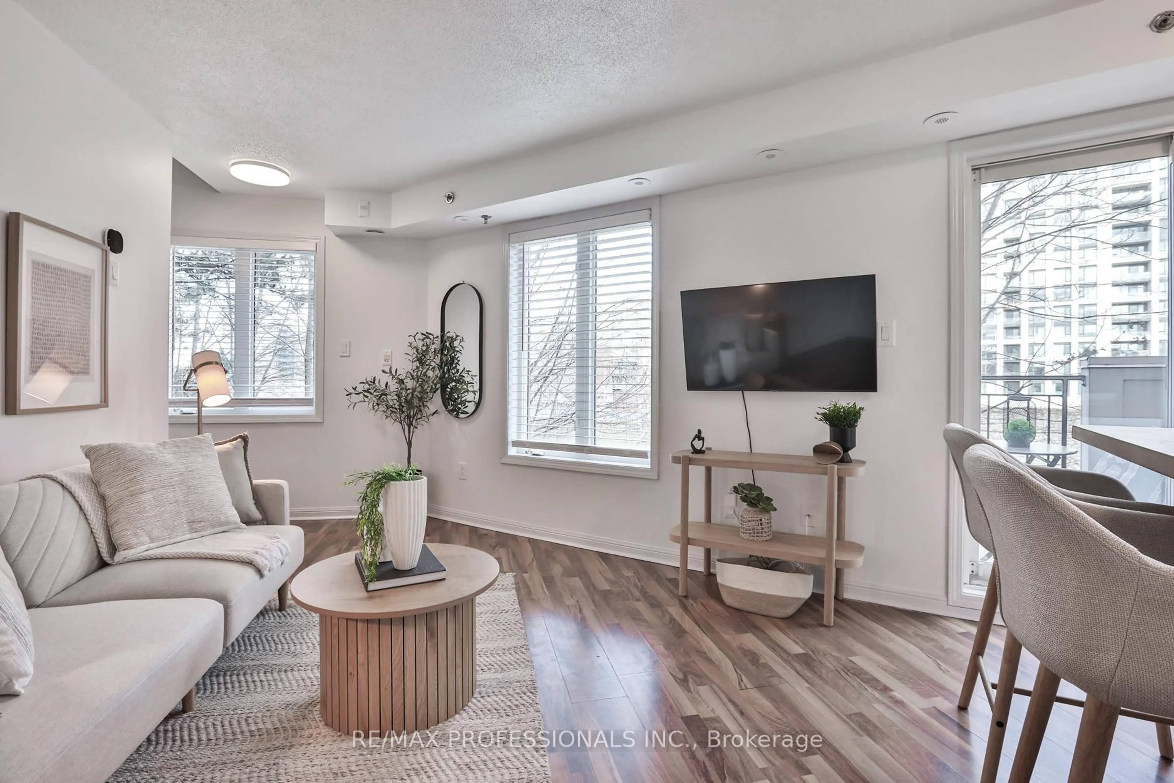 Living room with furniture, wood/laminate floor for 80 Joe Shuster Way #1706, Toronto Ontario M6K 1Y5