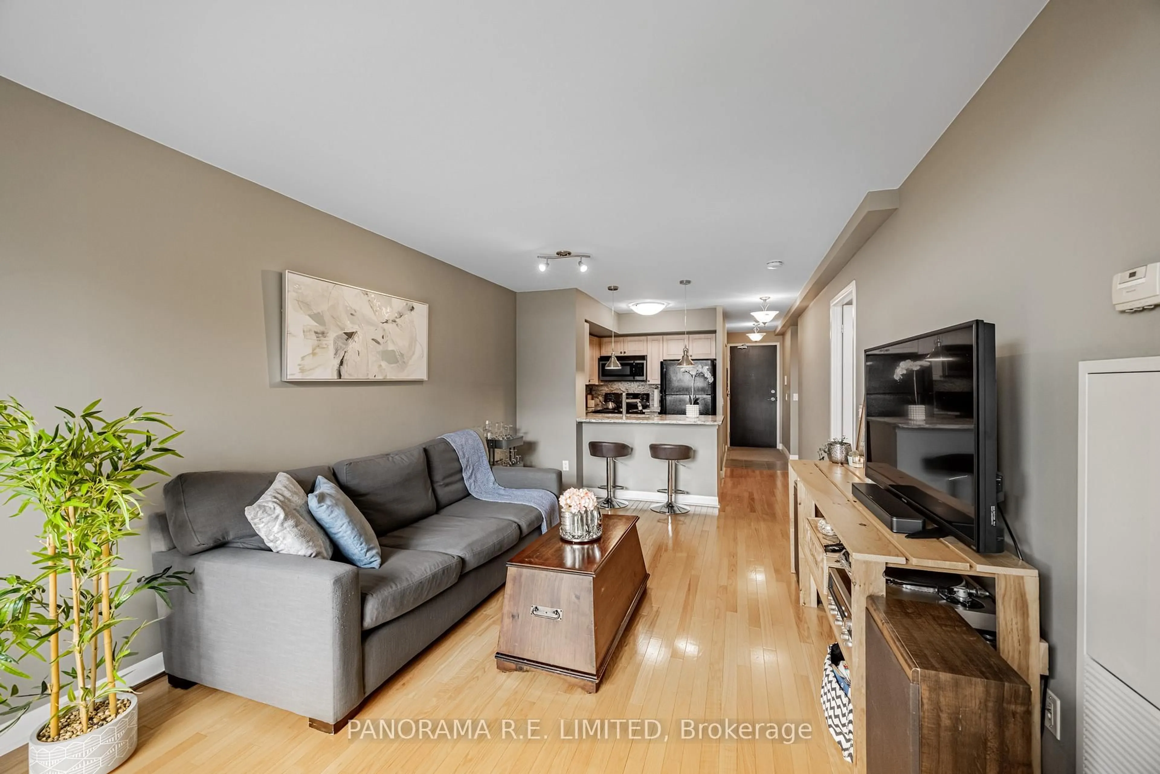 Living room with furniture, wood/laminate floor for 225 Sherway Gardens Rd #310, Toronto Ontario M9C 0A3
