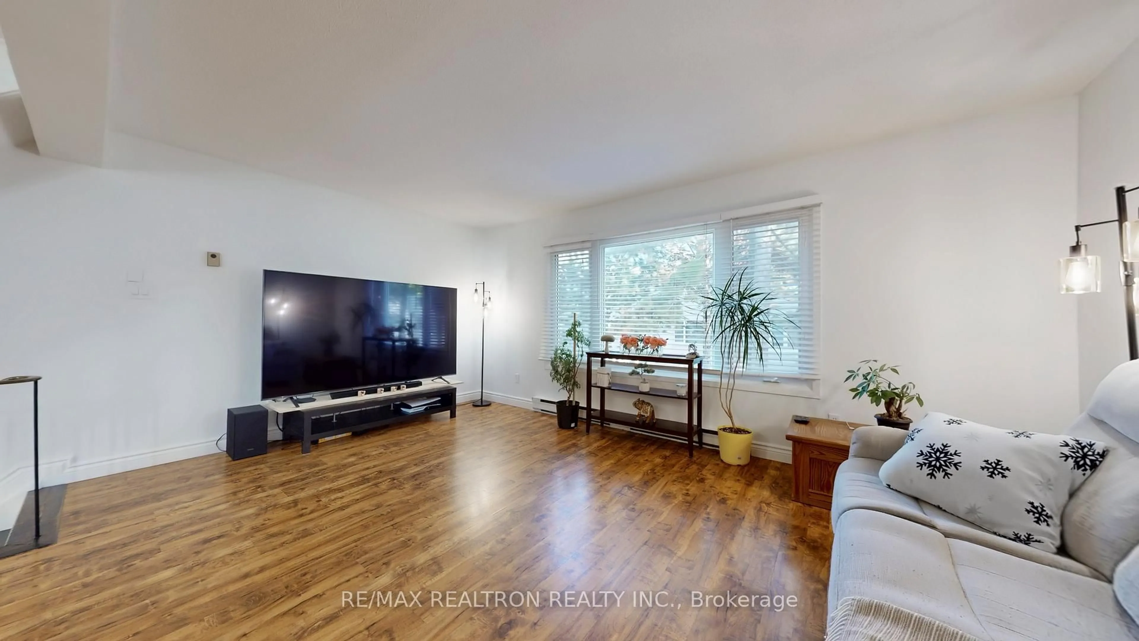 Living room with furniture, wood/laminate floor for 2440 Bromsgrove Rd #77, Mississauga Ontario L5J 4J7