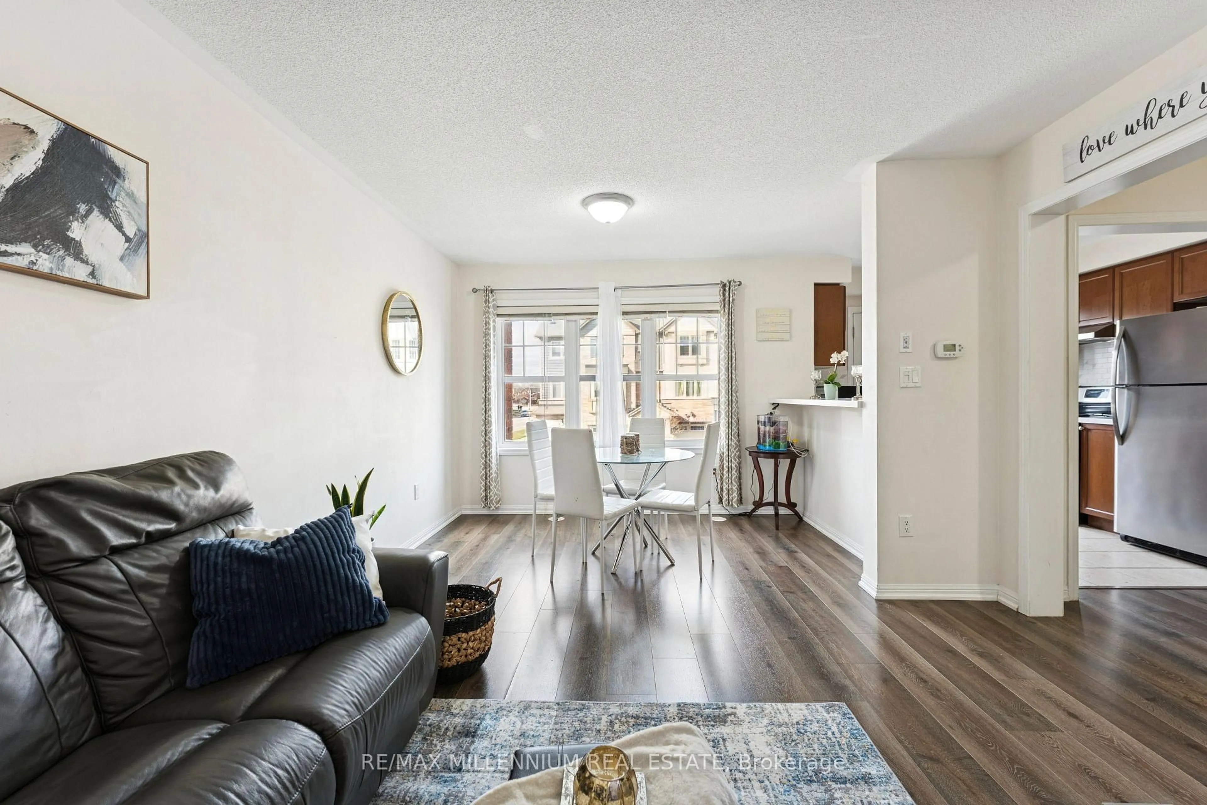 Living room with furniture, wood/laminate floor for 53 Colonel Frank Ching Cres, Brampton Ontario L6Y 5W5