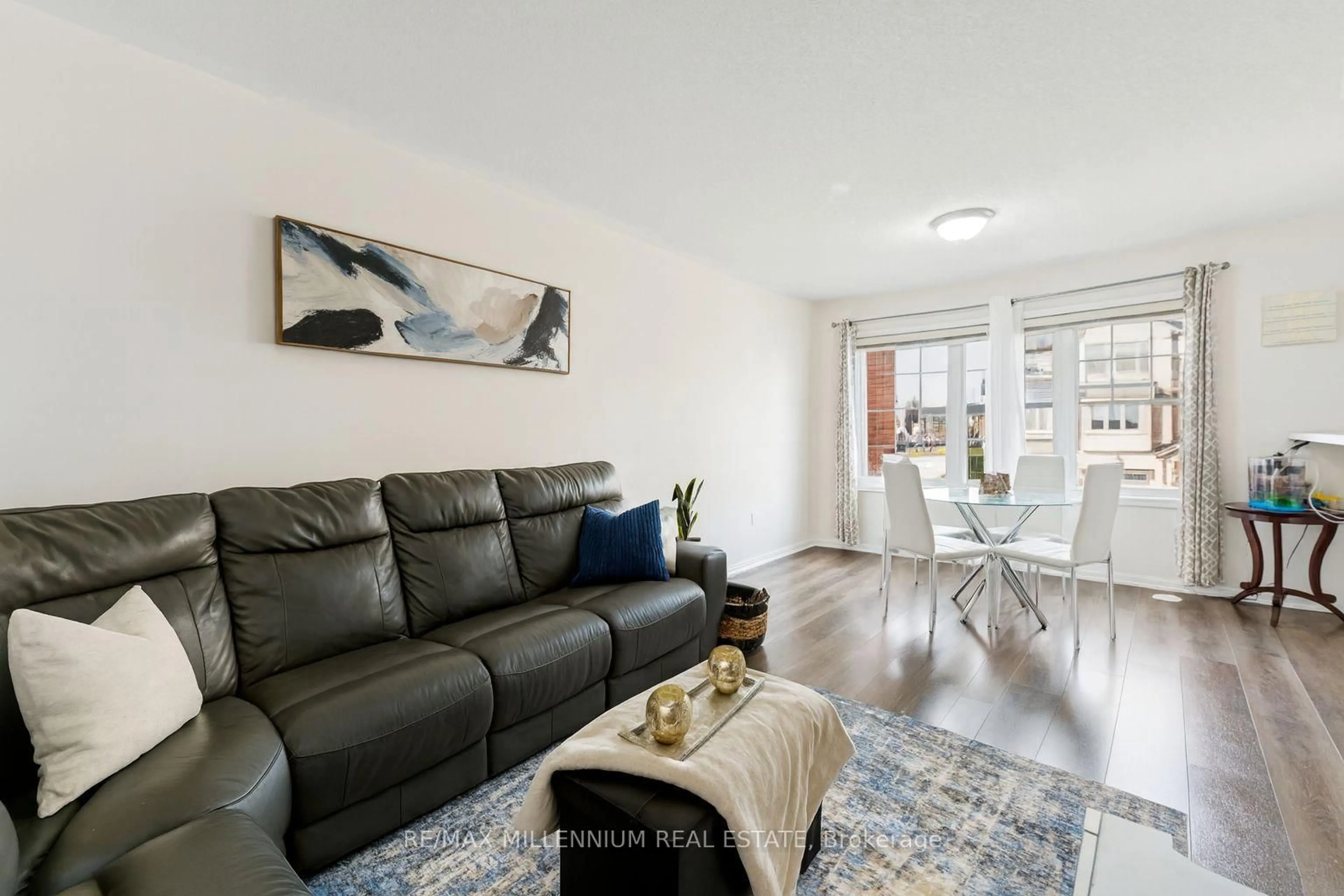 Living room with furniture, wood/laminate floor for 53 Colonel Frank Ching Cres, Brampton Ontario L6Y 5W5