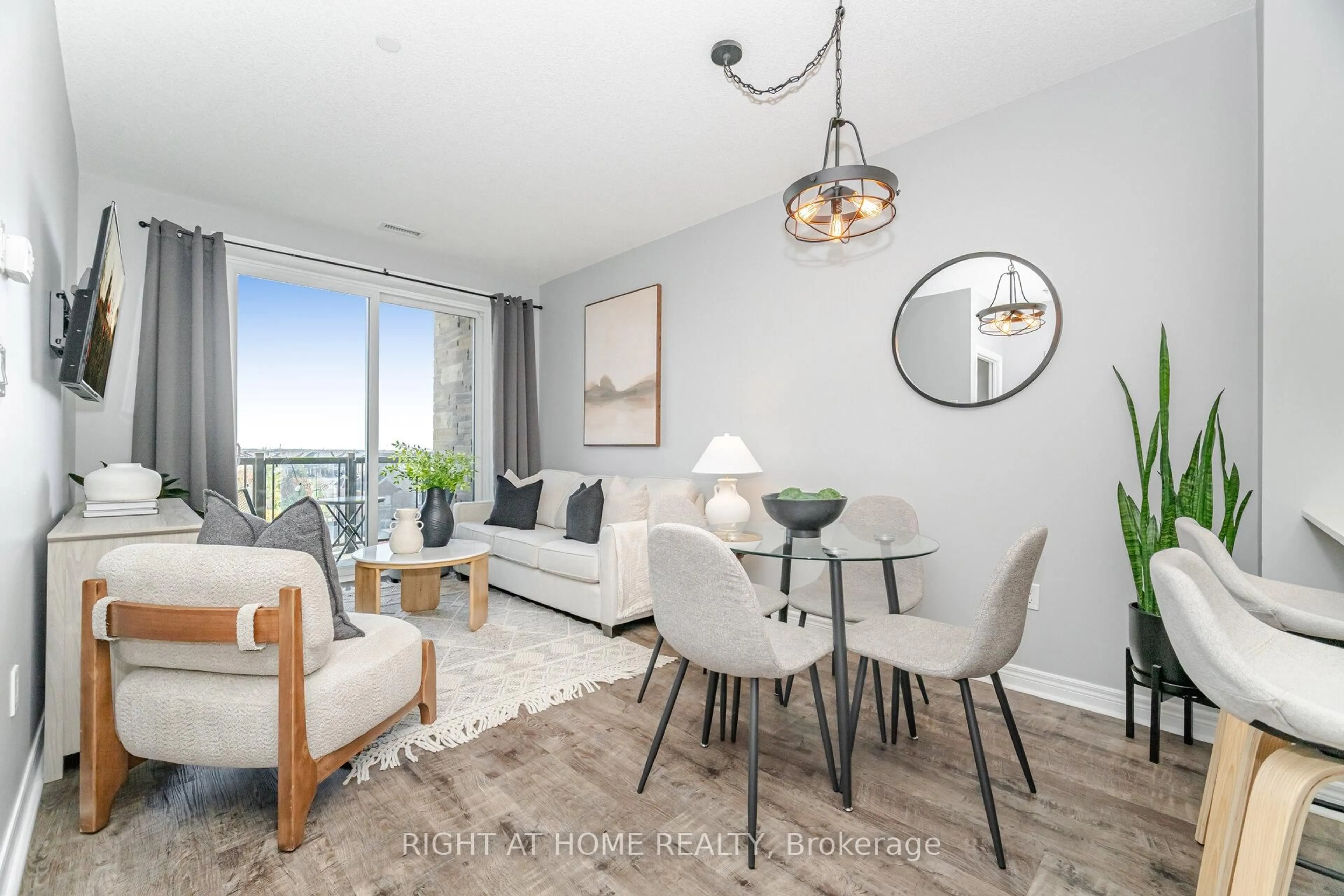 Living room with furniture, wood/laminate floor for 33 Whitmer St #408, Milton Ontario L9T 8P9