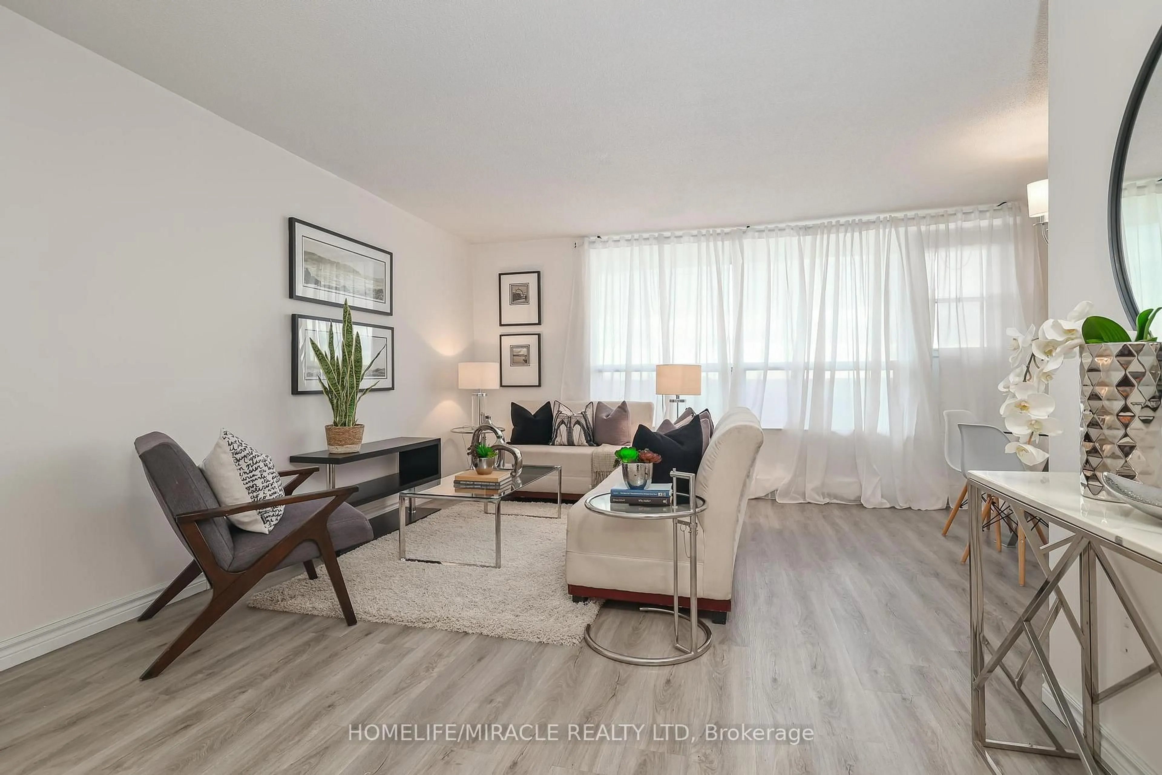 Living room with furniture, wood/laminate floor for 3390 Weston Rd #1706, Toronto Ontario M9M 2X3