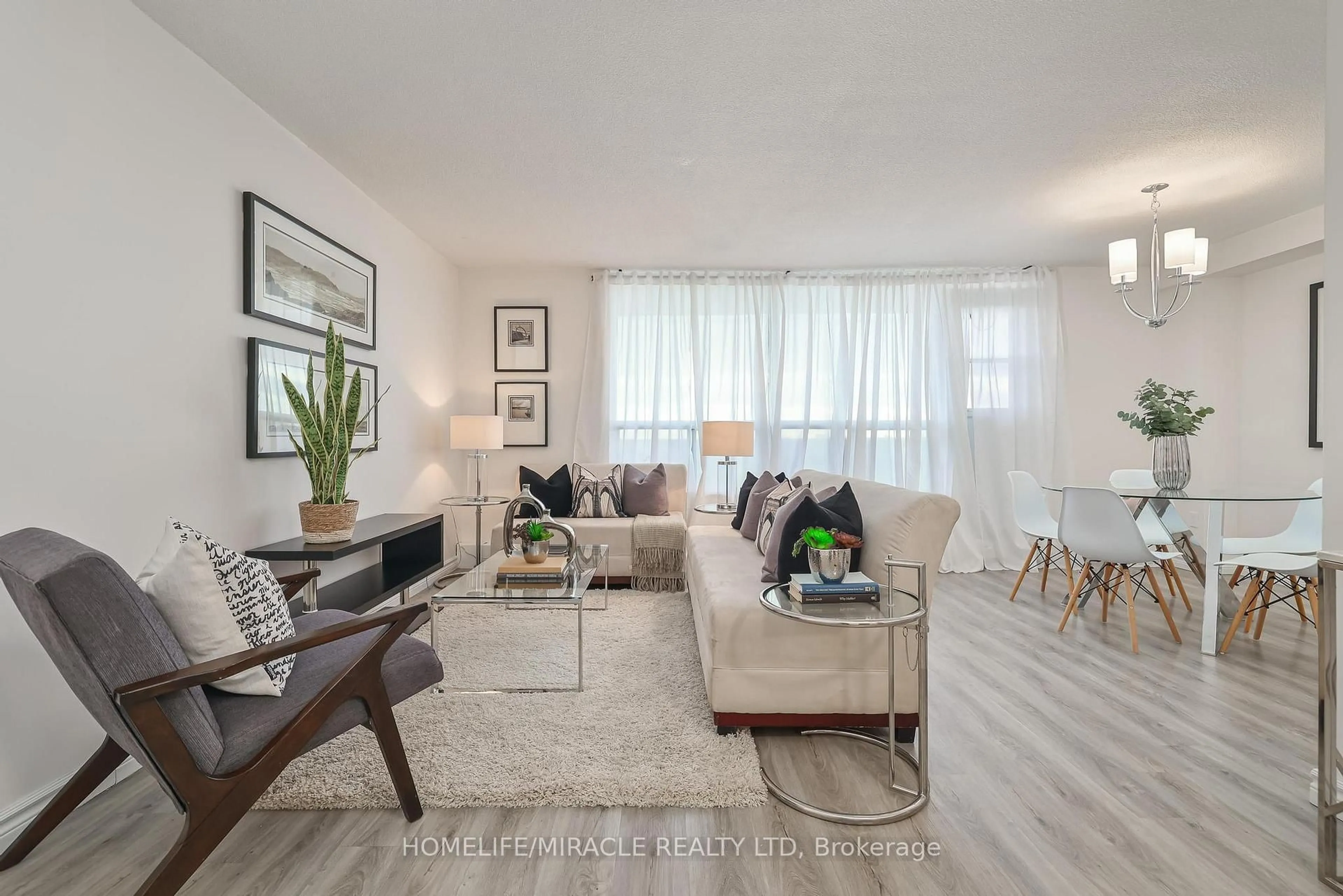 Living room with furniture, wood/laminate floor for 3390 Weston Rd #1706, Toronto Ontario M9M 2X3