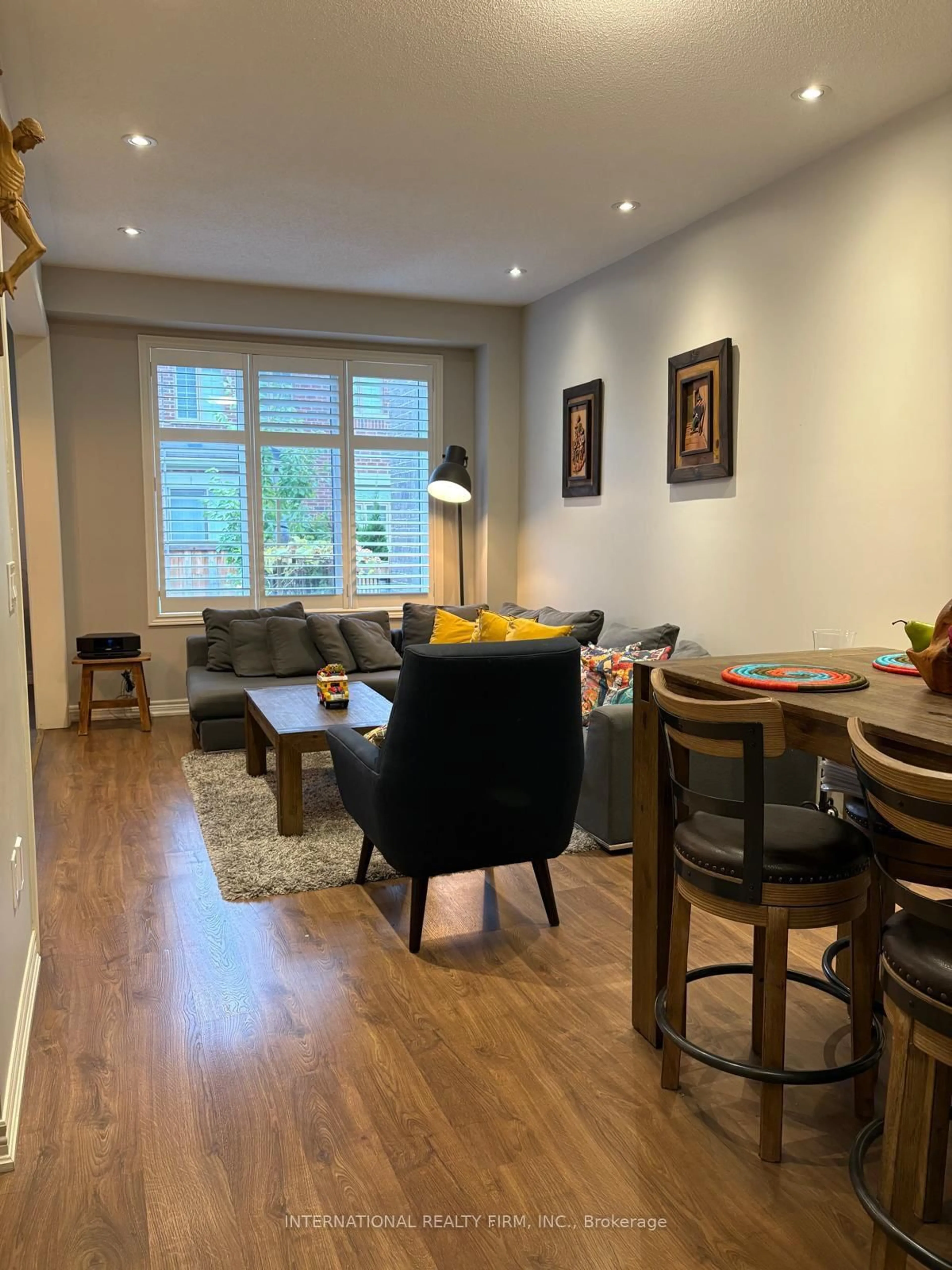 Living room with furniture, wood/laminate floor for 1477 Pratt Hts, Milton Ontario L9E 1J3