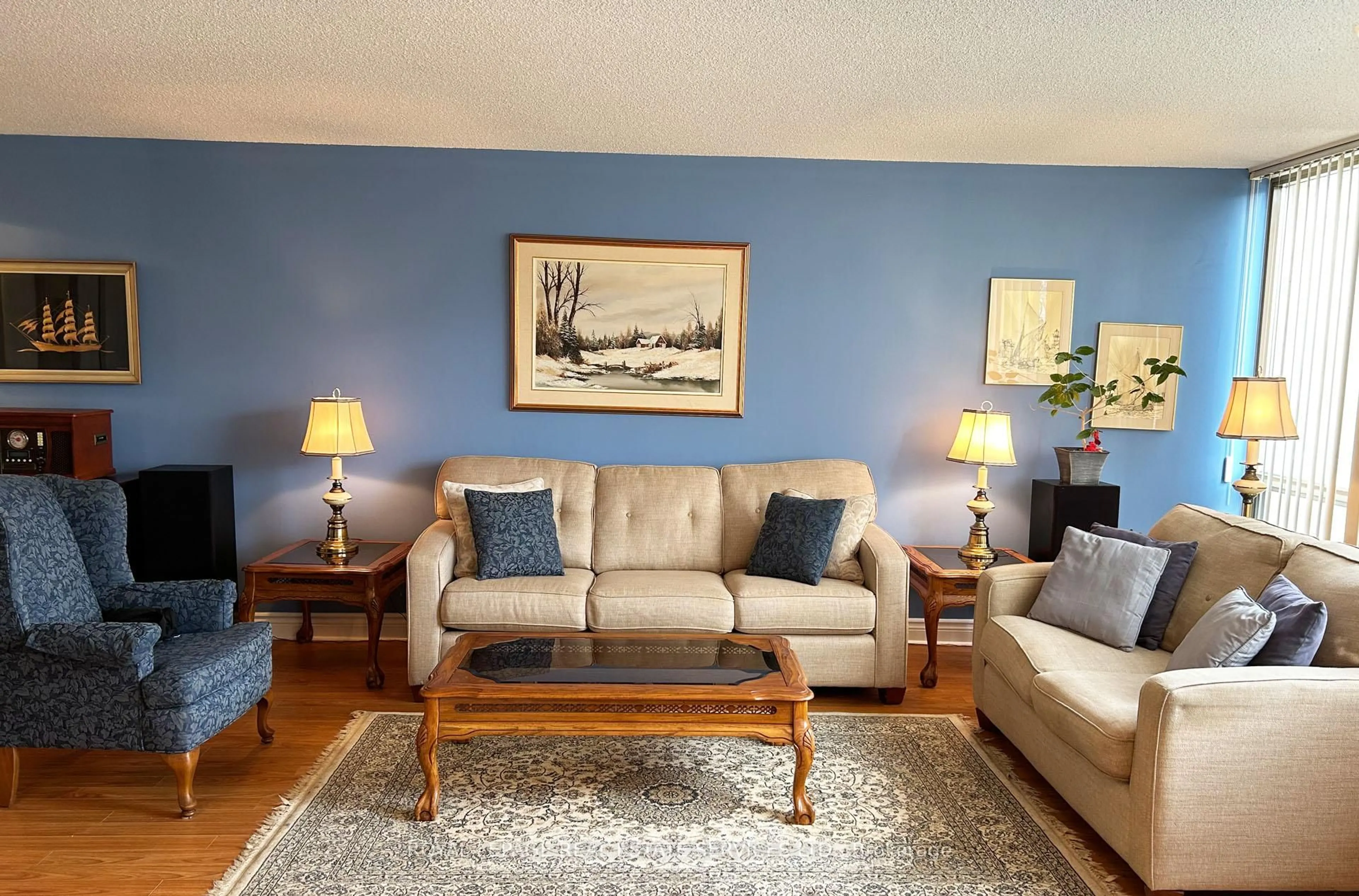 Living room with furniture, wood/laminate floor for 25 Fairview Rd #212, Mississauga Ontario L5B 3Y8