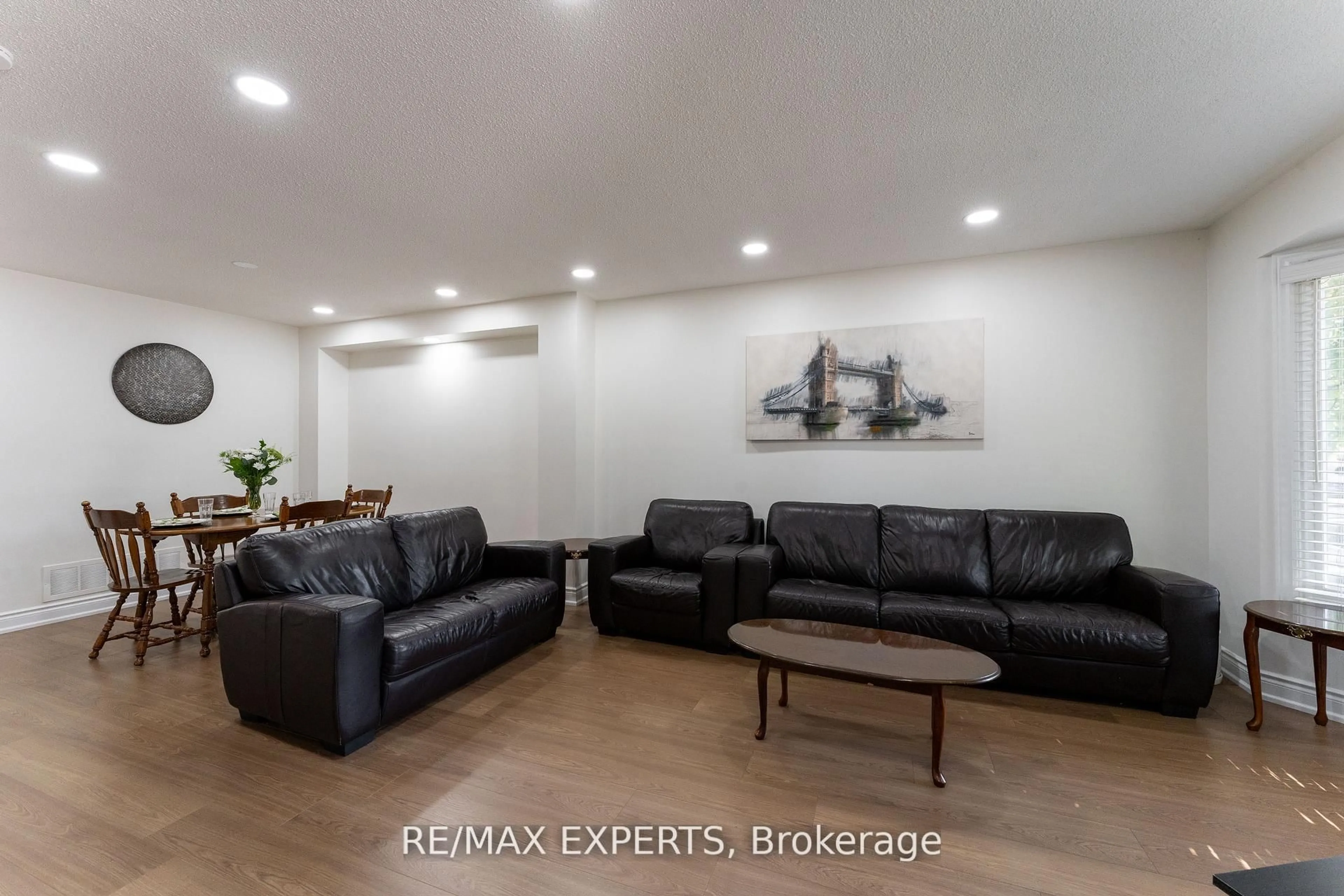 Living room with furniture, wood/laminate floor for 39 Softneedle Ave, Brampton Ontario L6R 1K4