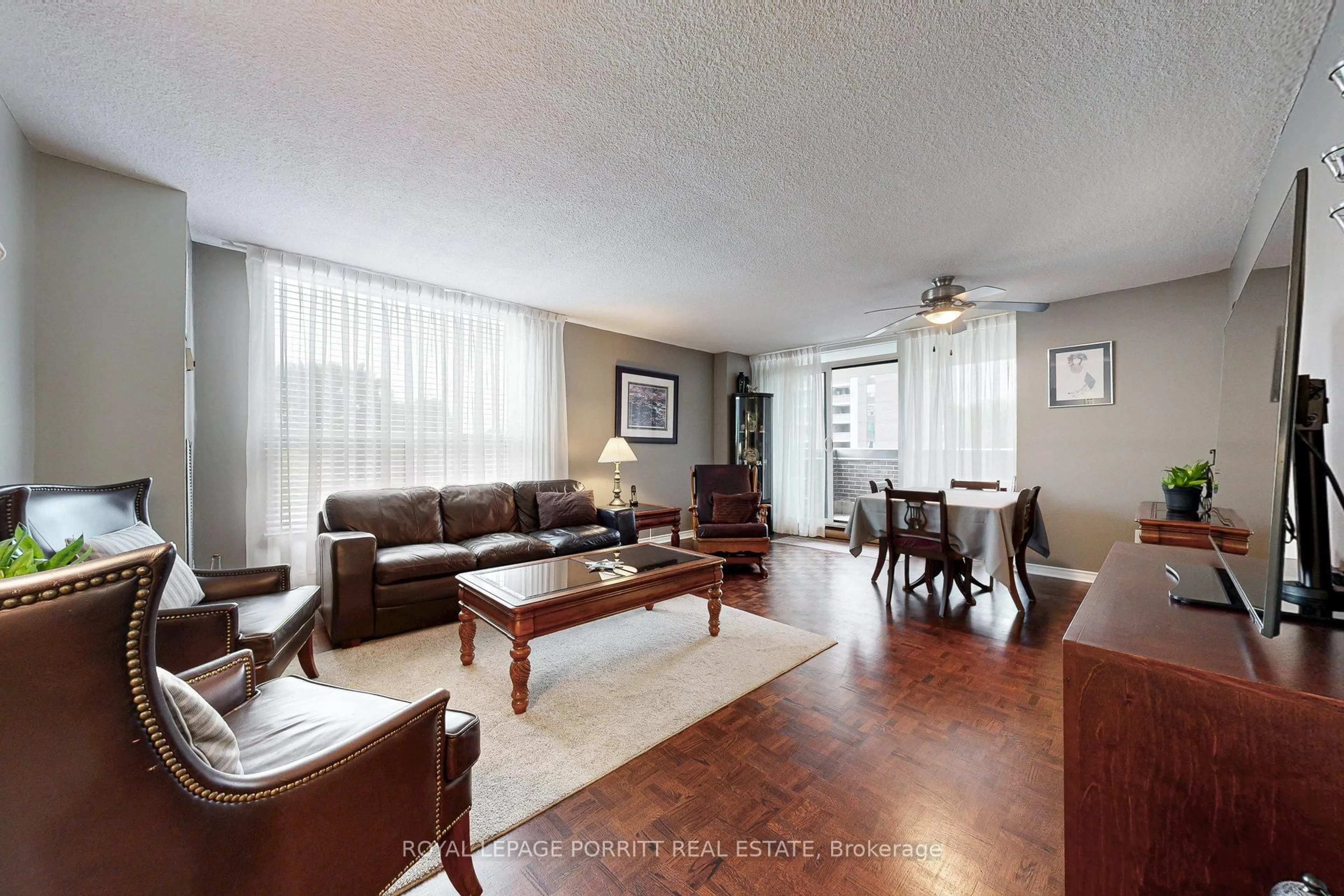 Living room with furniture, wood/laminate floor for 1535 Lakeshore Rd #201, Mississauga Ontario L5E 3E2