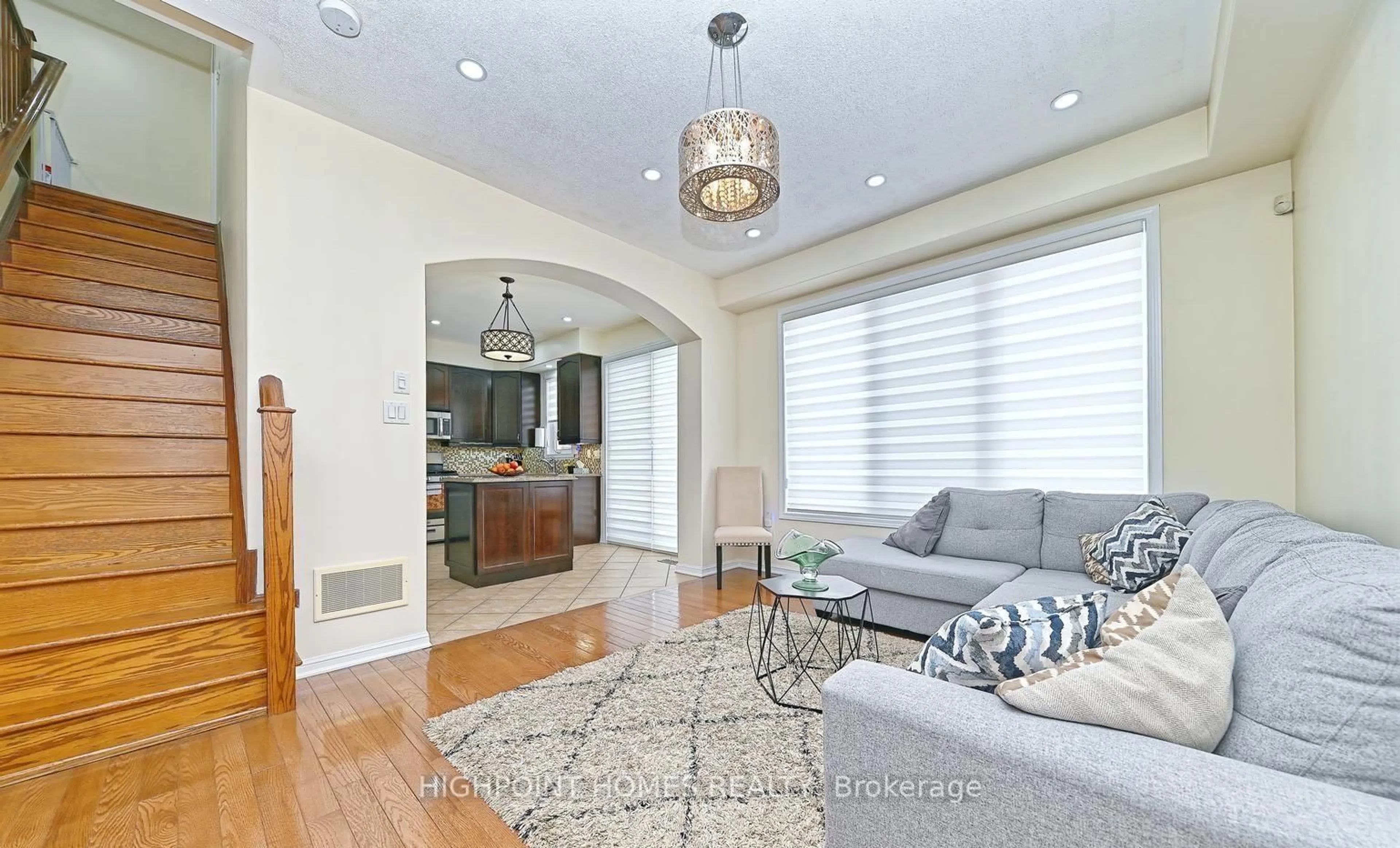 Living room with furniture, wood/laminate floor for 993 Whewell Trail, Milton Ontario L9T 8C2