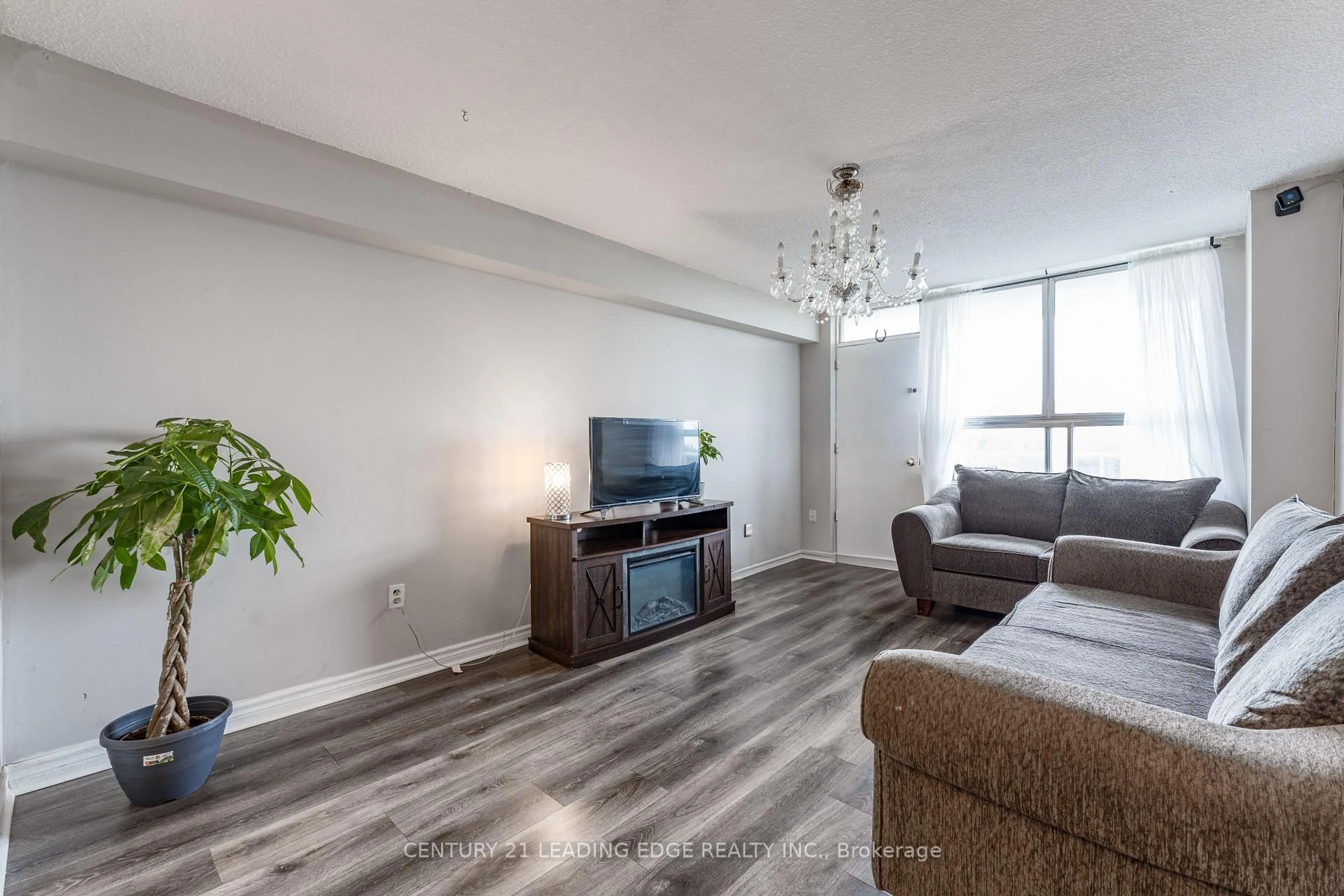 Living room with furniture, wood/laminate floor for 940 Caledonia Rd #611, Toronto Ontario M6B 2G8