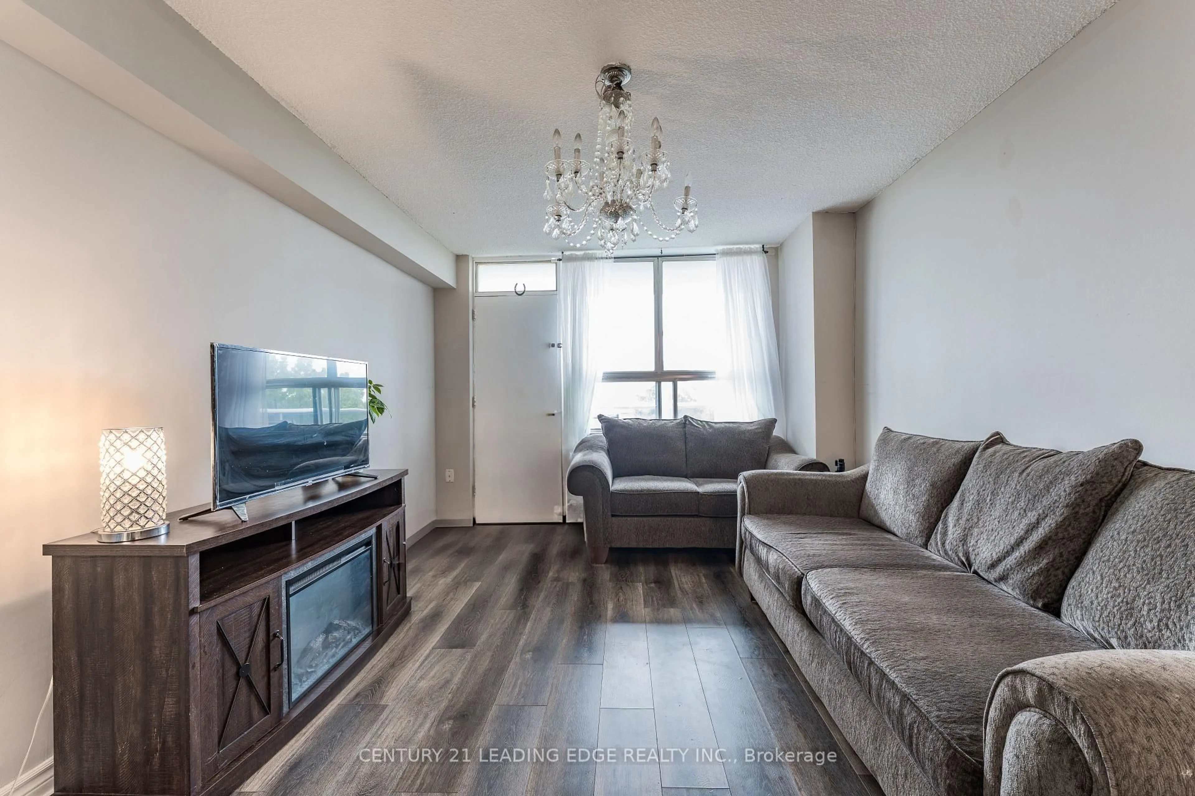 Living room with furniture, wood/laminate floor for 940 Caledonia Rd #611, Toronto Ontario M6B 2G8