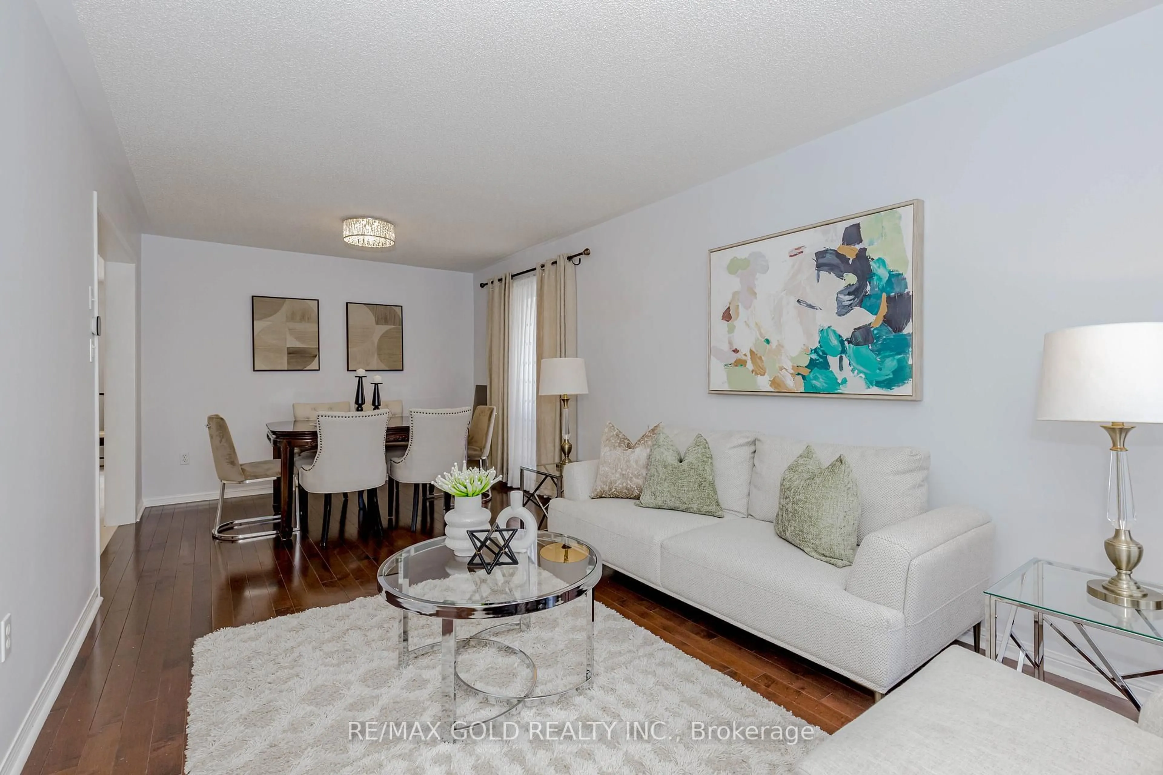 Living room with furniture, wood/laminate floor for 7399 Terragar Blvd, Mississauga Ontario L5N 8G7