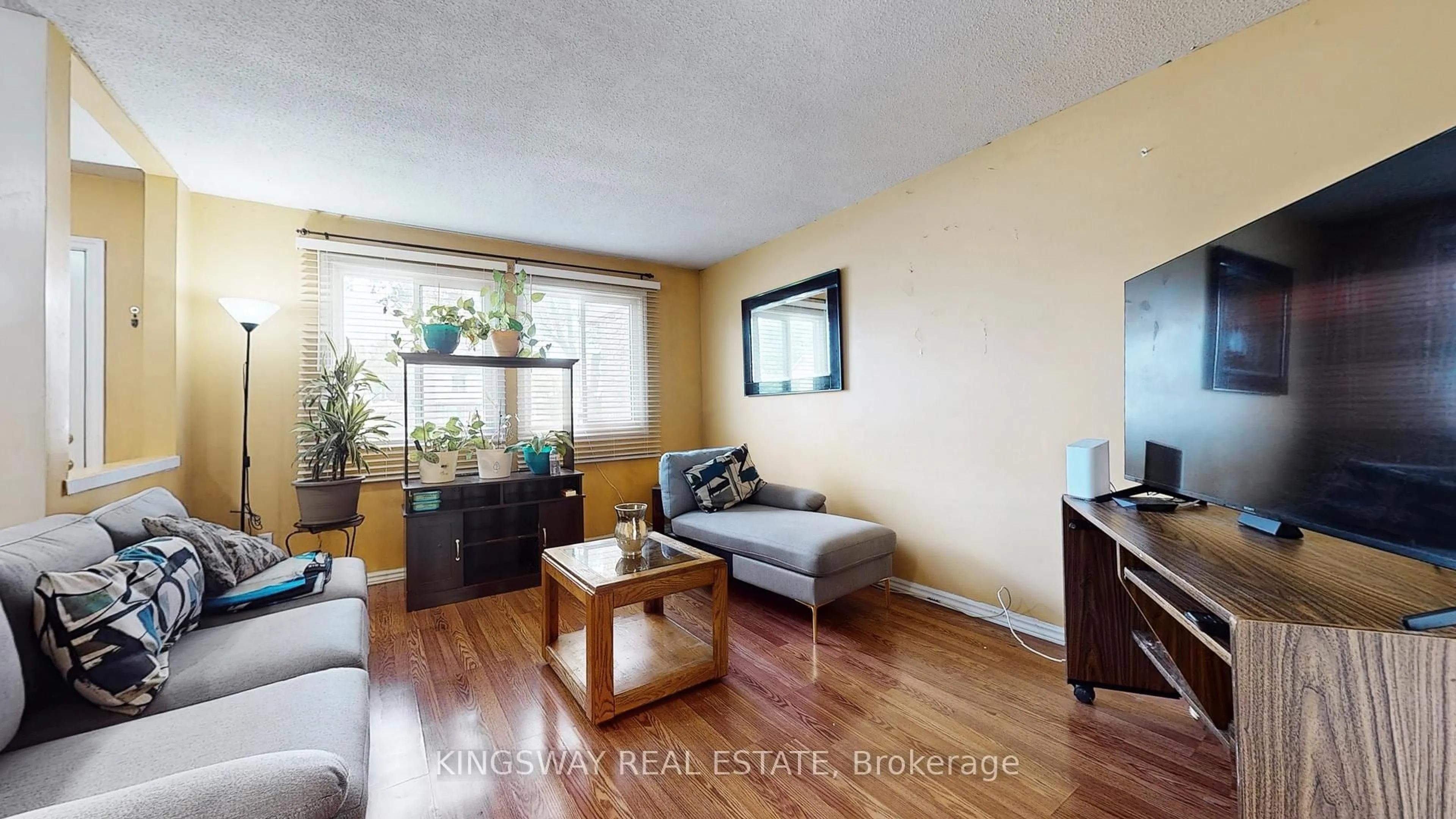 Living room with furniture, wood/laminate floor for 105 Hansen Rd #111, Brampton Ontario L6V 3C9