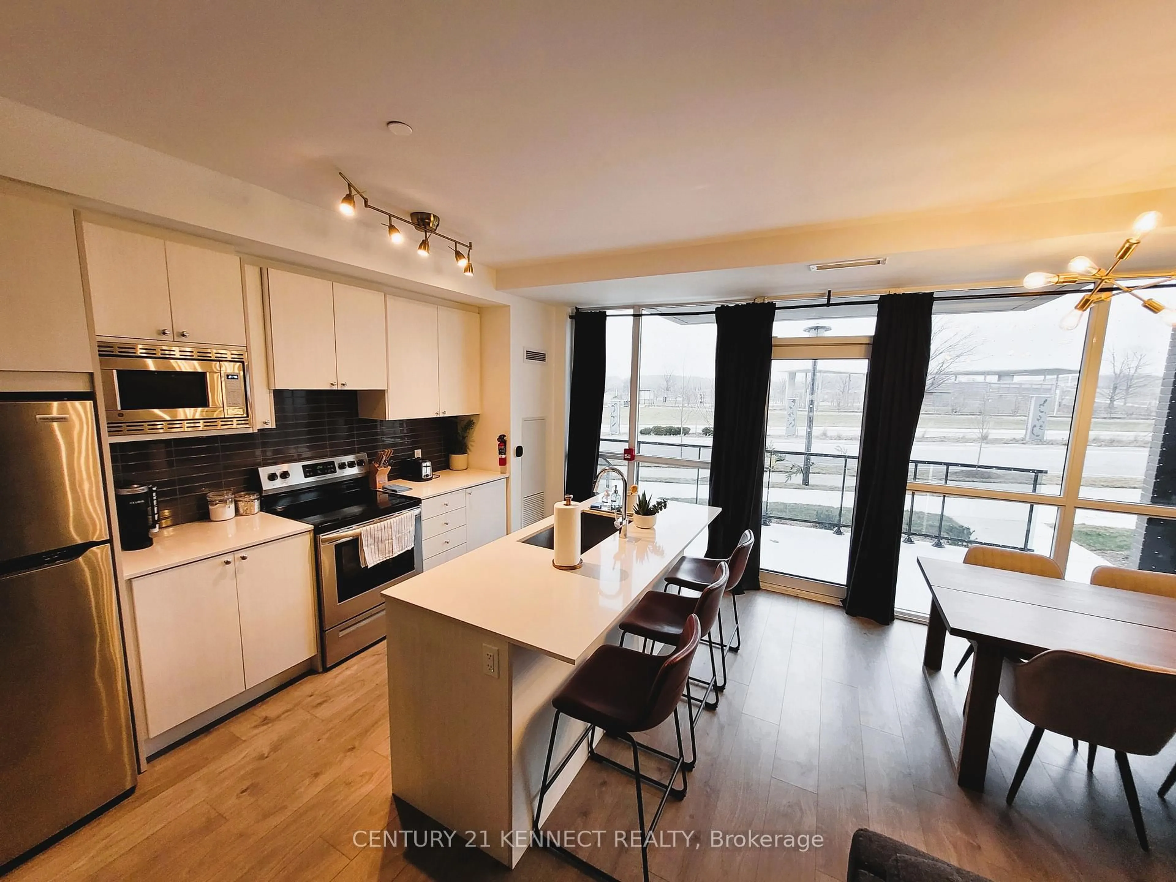 Open concept kitchen, wood/laminate floor for 60 George Butchart Dr #TH2, Toronto Ontario M3K 0E1