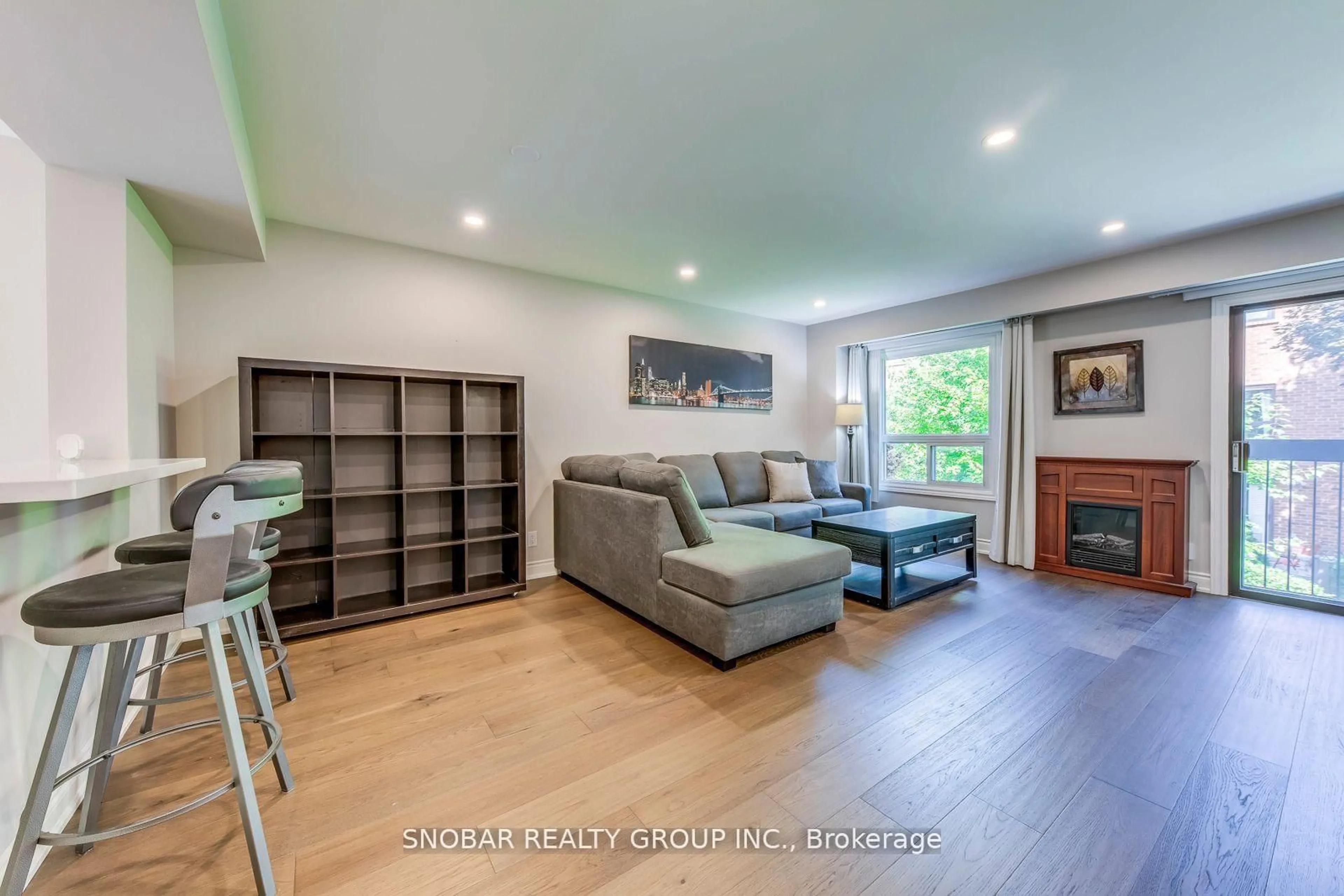 Living room with furniture, wood/laminate floor for 35 Maple Branch Path, Toronto Ontario M9P 3T4