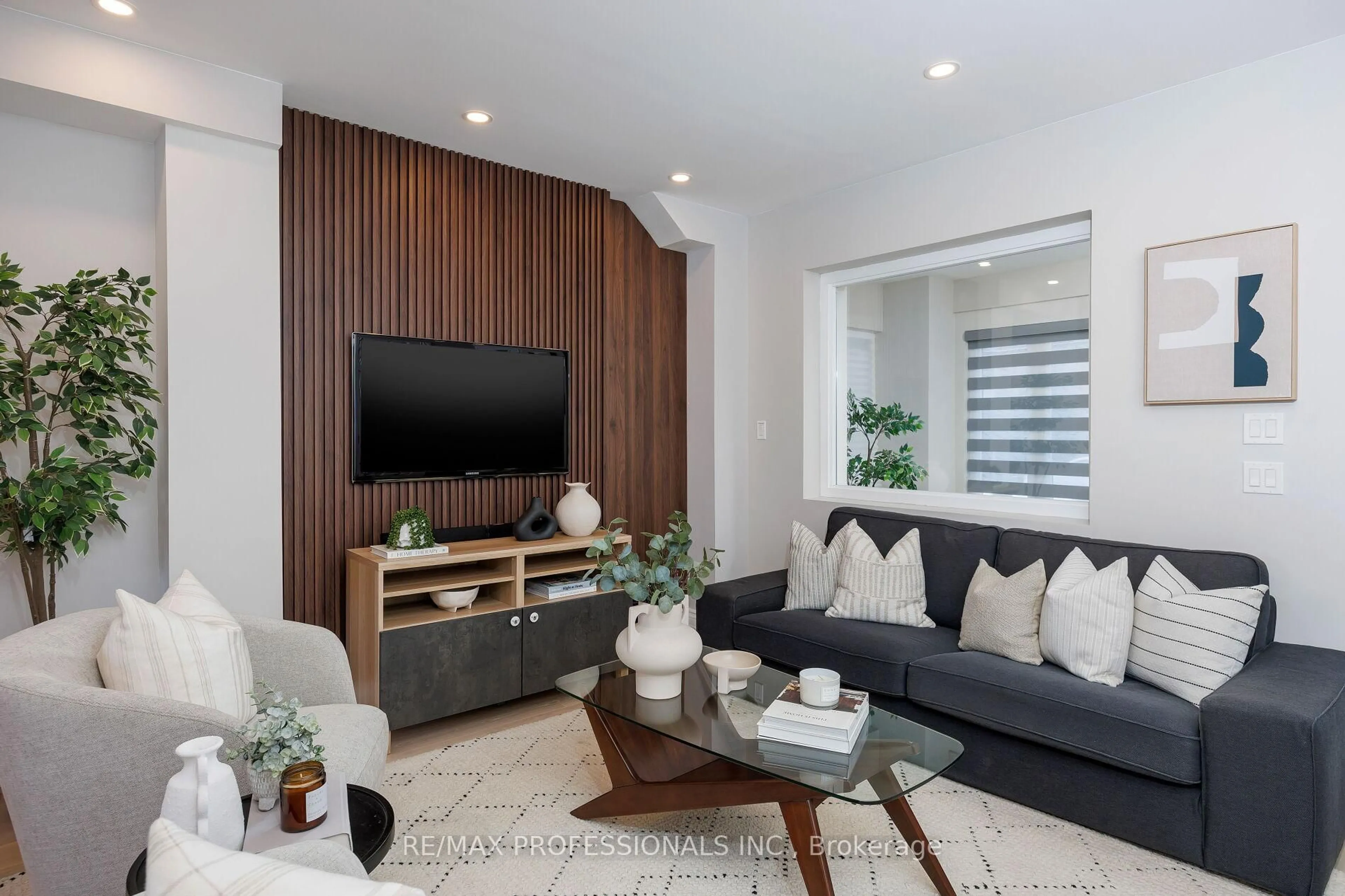 Living room with furniture, wood/laminate floor for 545 Runnymede Rd, Toronto Ontario M6S 2Z8