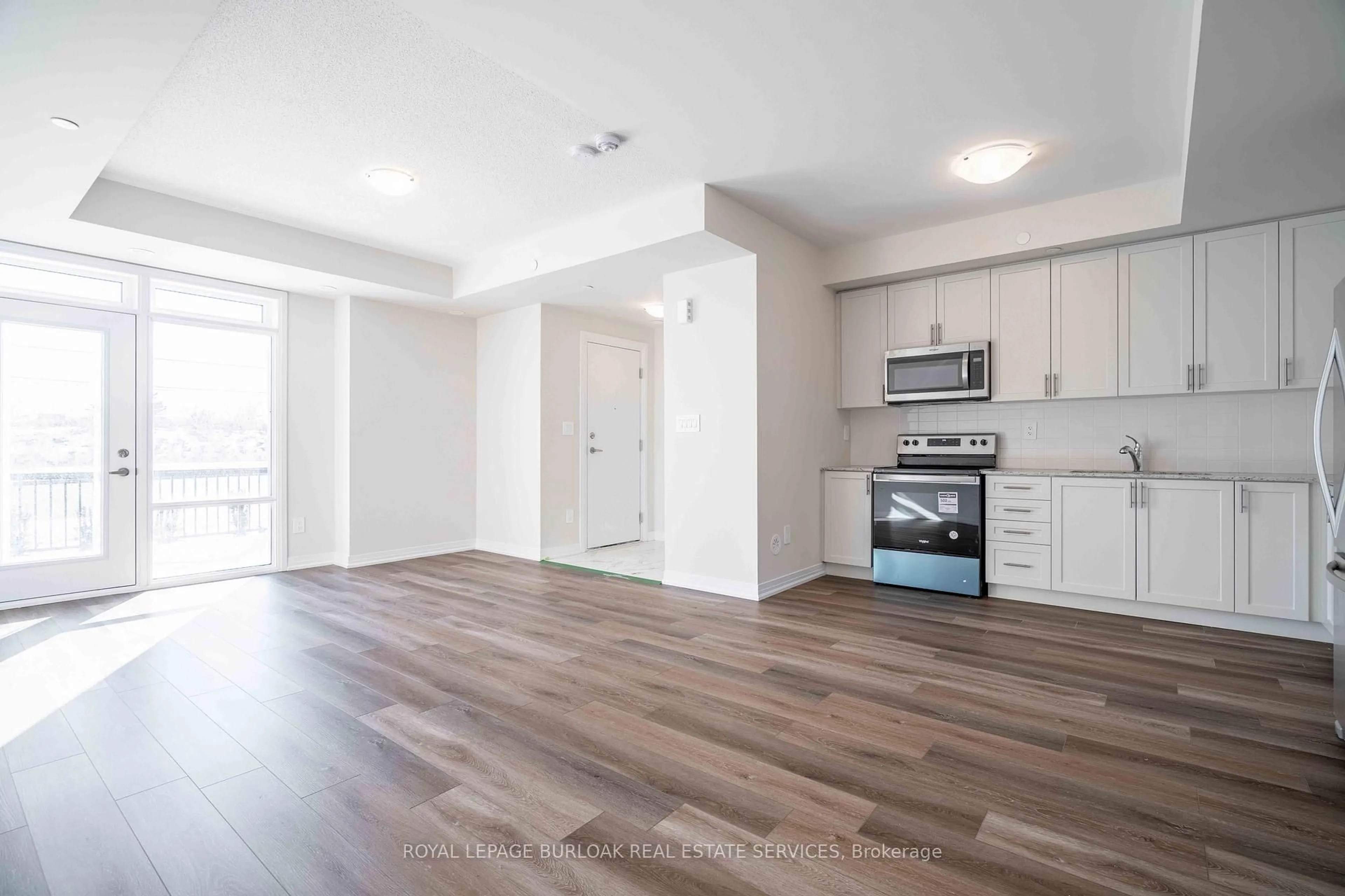 Open concept kitchen, wood/laminate floor for 1585 Rose Way #126, Milton Ontario L9E 1N4