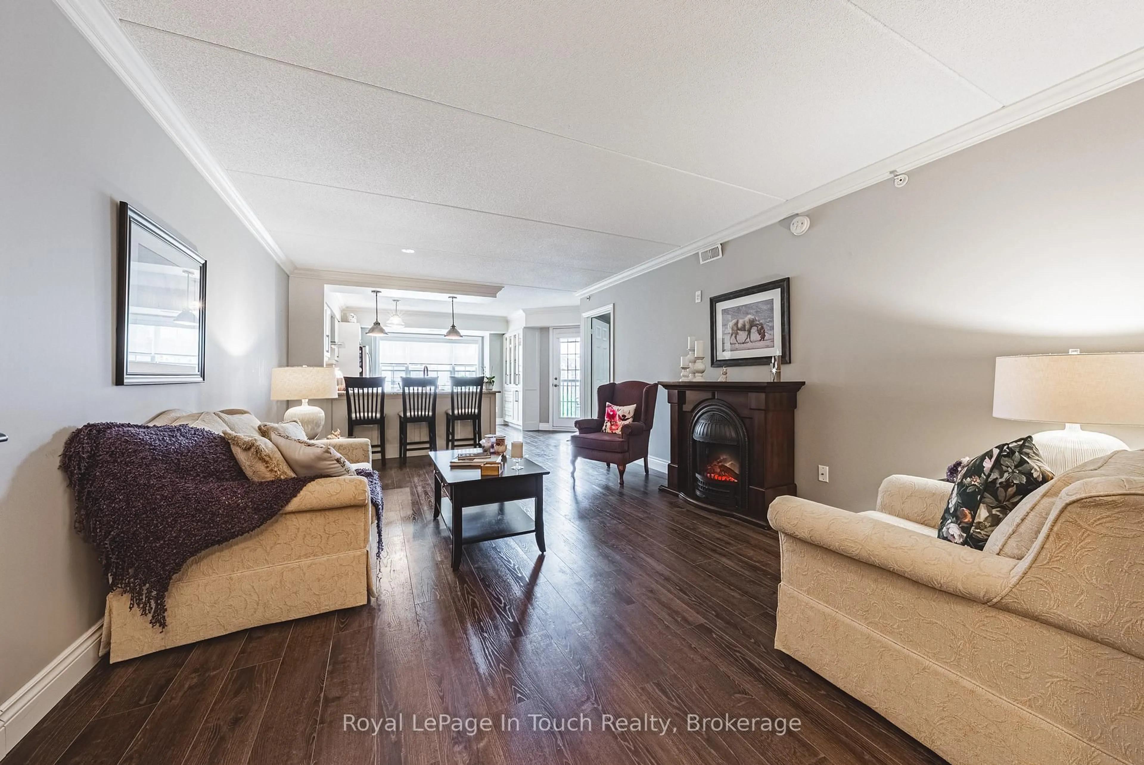 Living room with furniture, wood/laminate floor for 1491 Maple Ave #311, Milton Ontario L9T 0B8