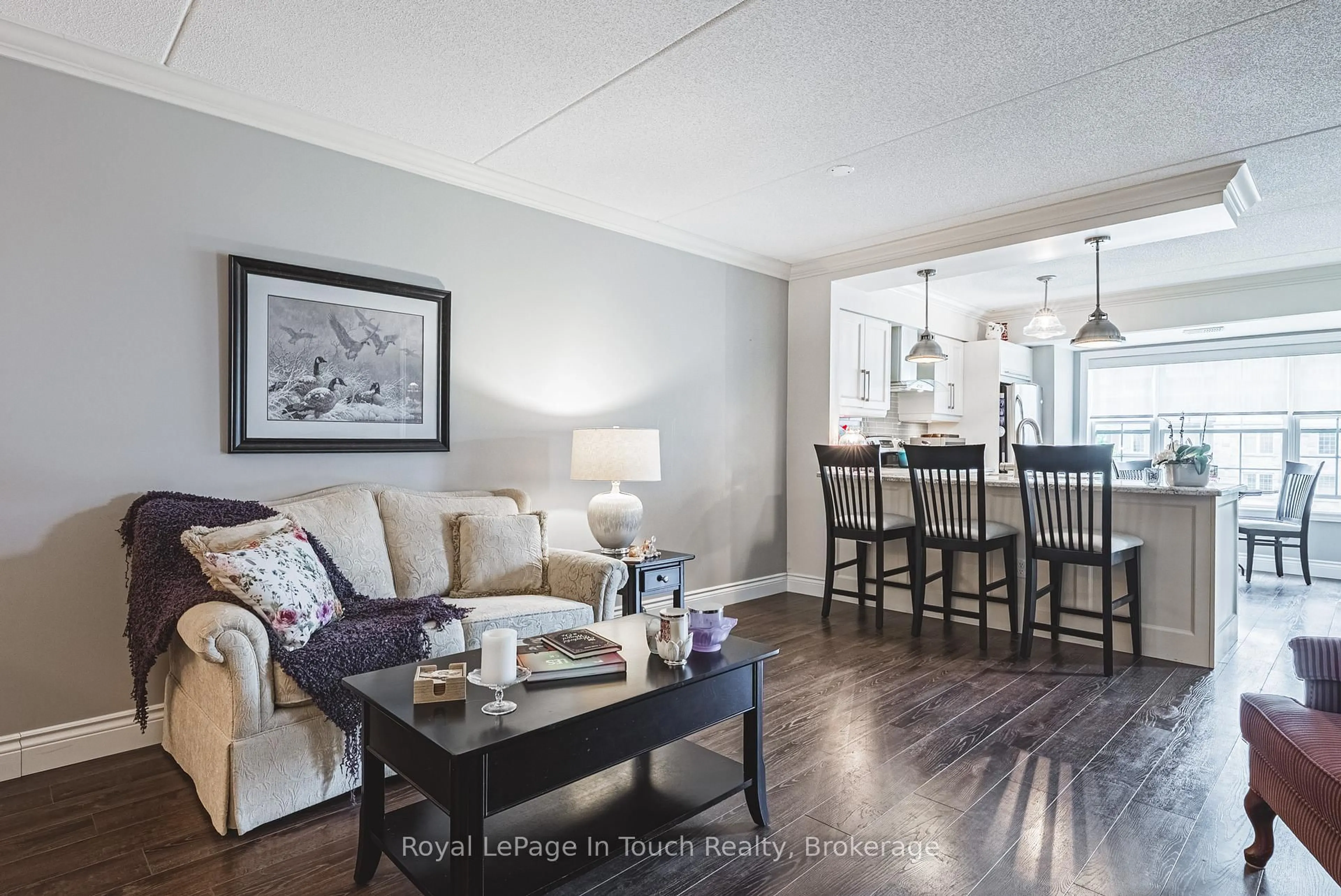 Living room with furniture, wood/laminate floor for 1491 Maple Ave #311, Milton Ontario L9T 0B8