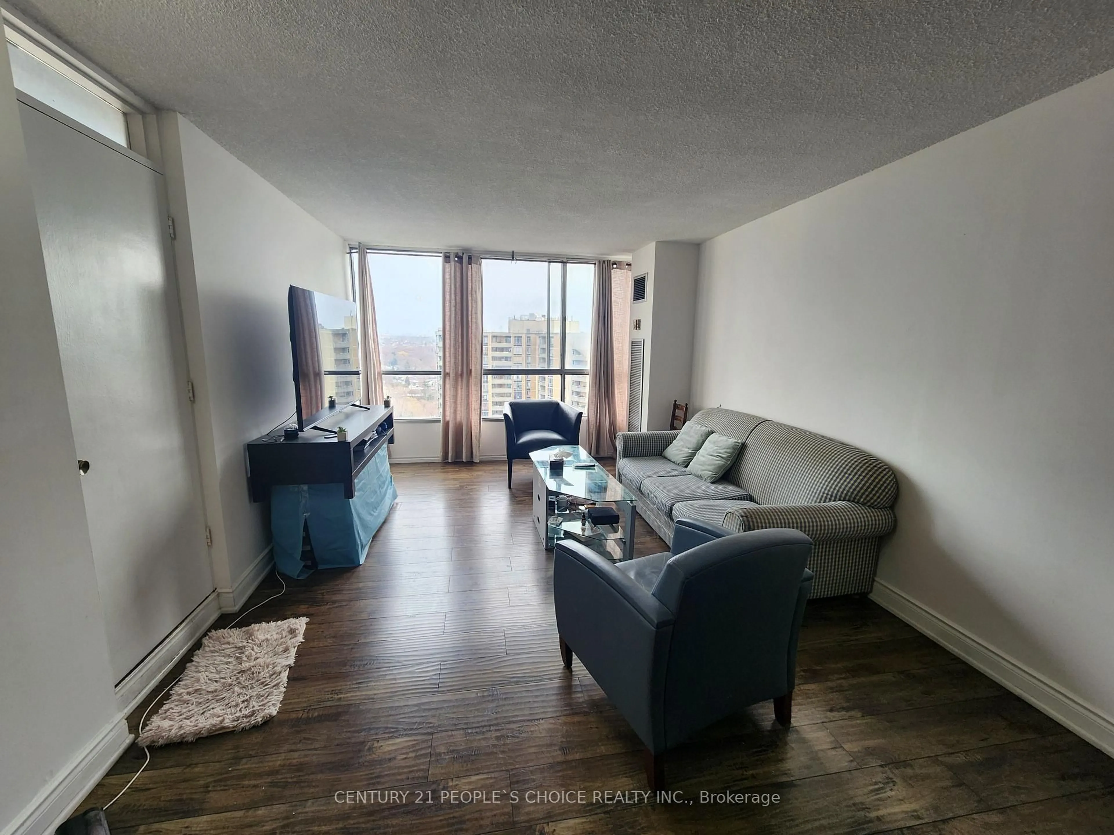 Living room with furniture, wood/laminate floor for 10 Martha Eaton Way #2311, Toronto Ontario M6M 5B3