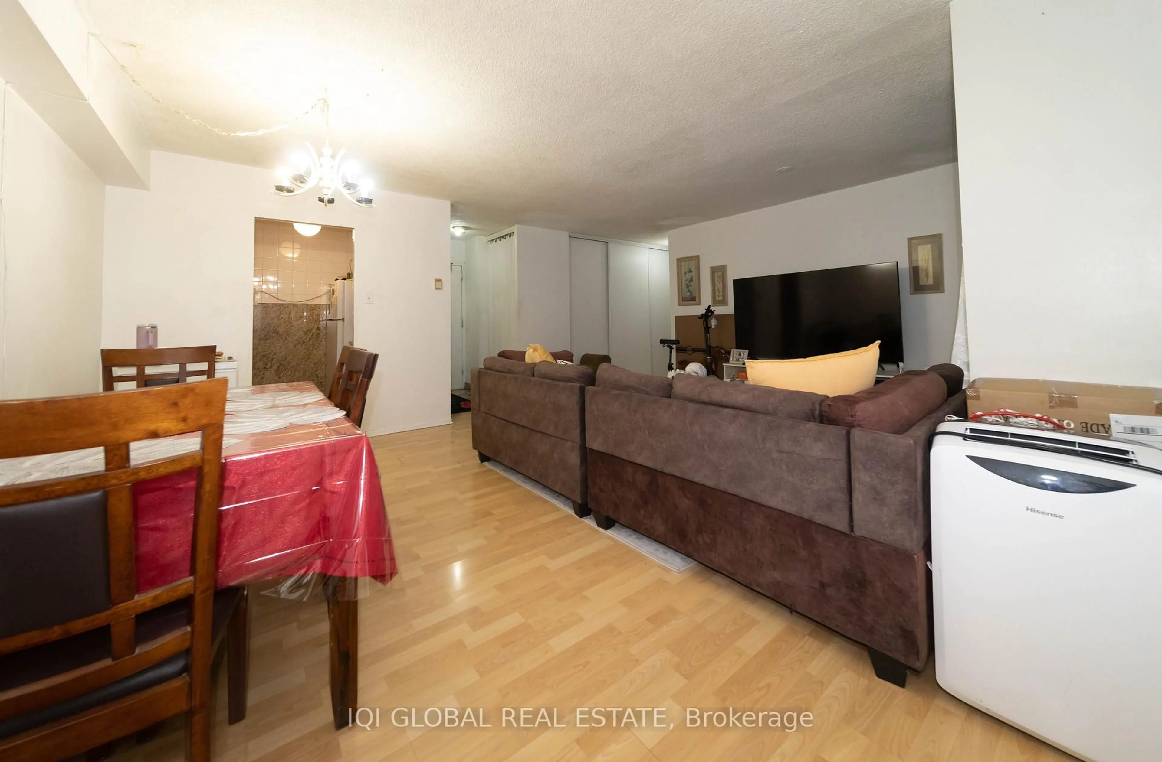 Living room with furniture, wood/laminate floor for 50 Lotherton Ptwy #1115, Toronto Ontario M6B 2G8