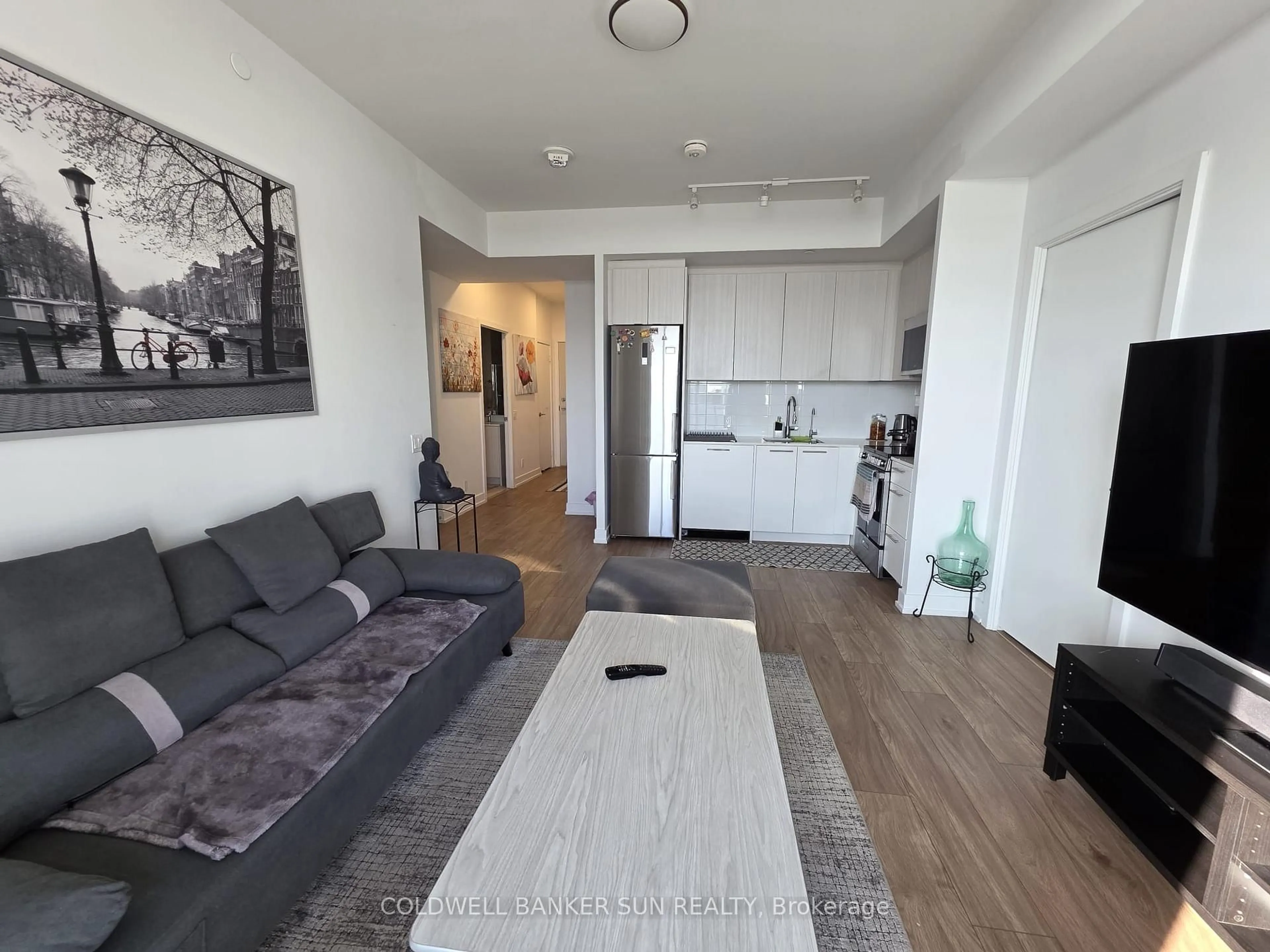 Living room with furniture, wood/laminate floor for 215 Veterans Dr #601, Brampton Ontario L7A 4S6
