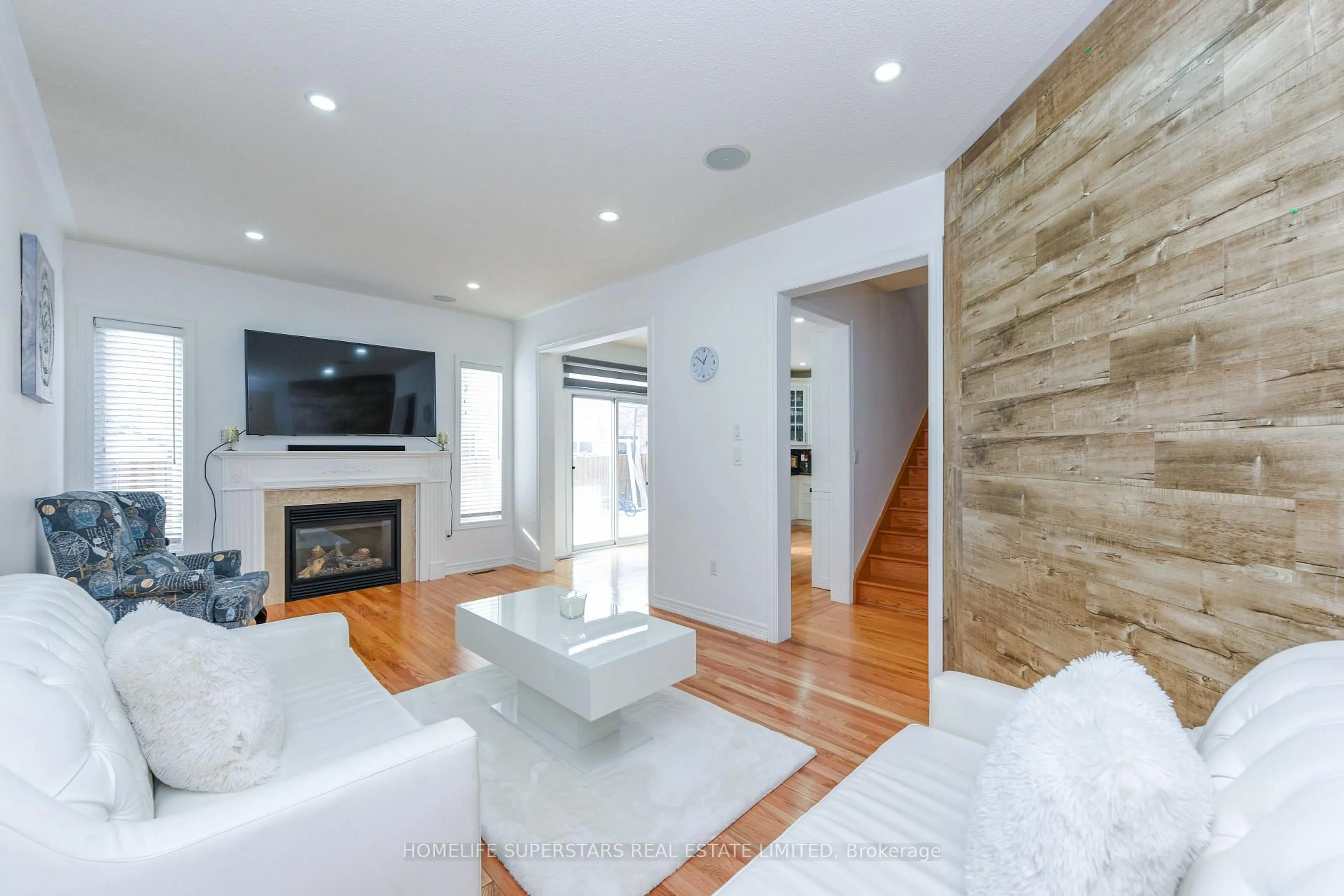 Living room with furniture, wood/laminate floor for 27 Dovehaven Cres, Brampton Ontario L6P 2N8