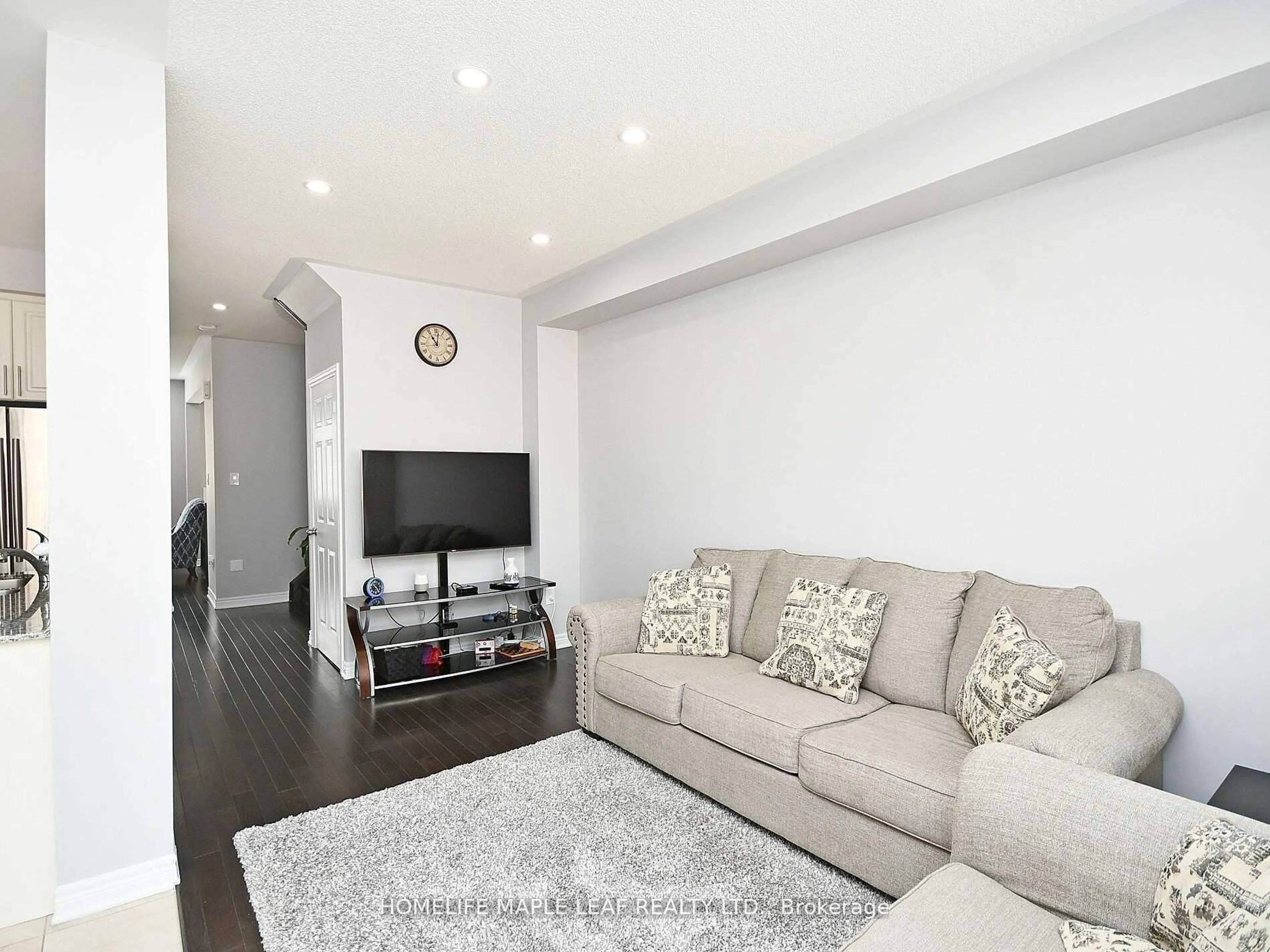 Living room with furniture, wood/laminate floor for 76 Rockman Cres, Brampton Ontario L7A 3Z9
