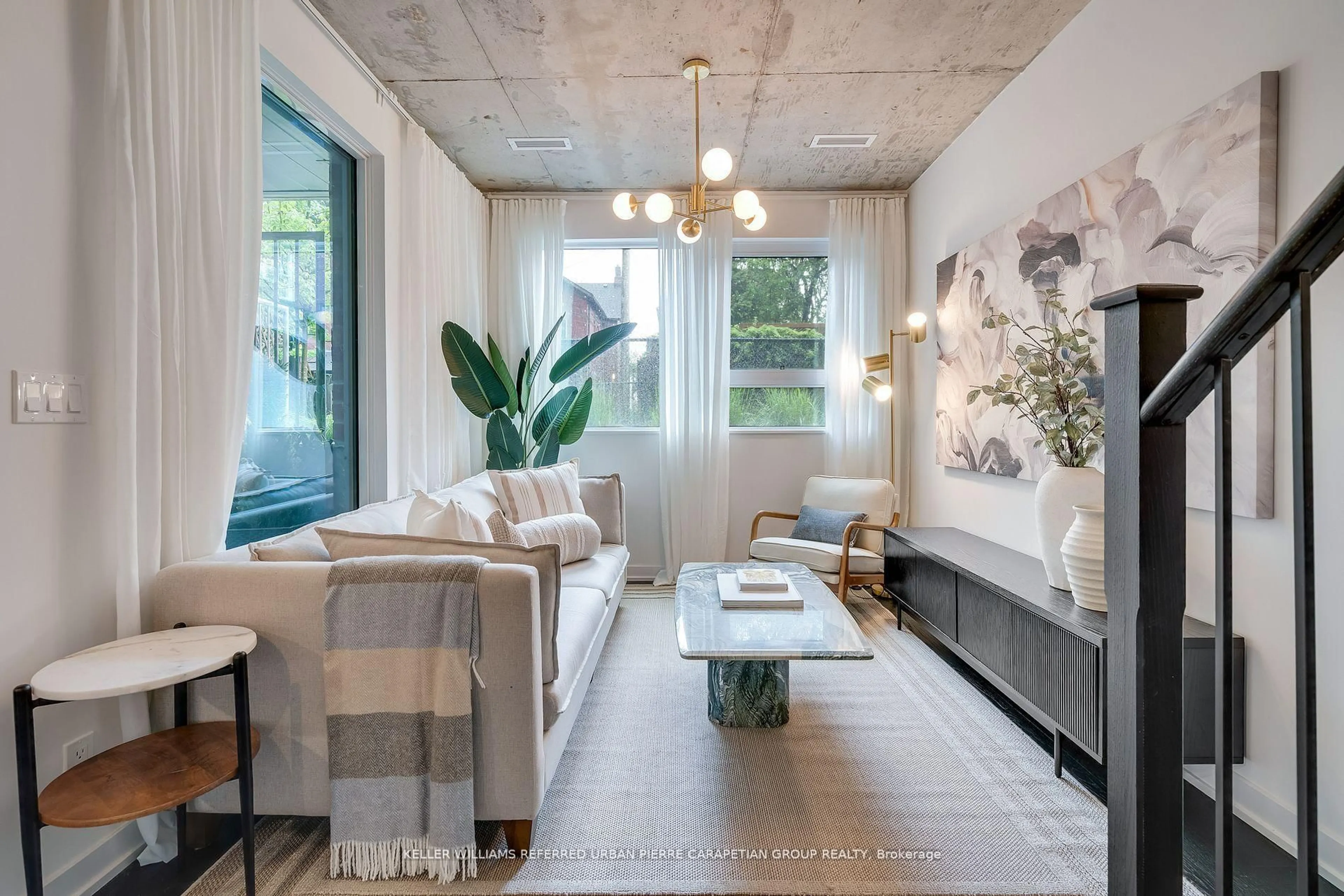 Living room with furniture, cement floor for 57 Brock Ave #TH 109, Toronto Ontario M6K 0H3