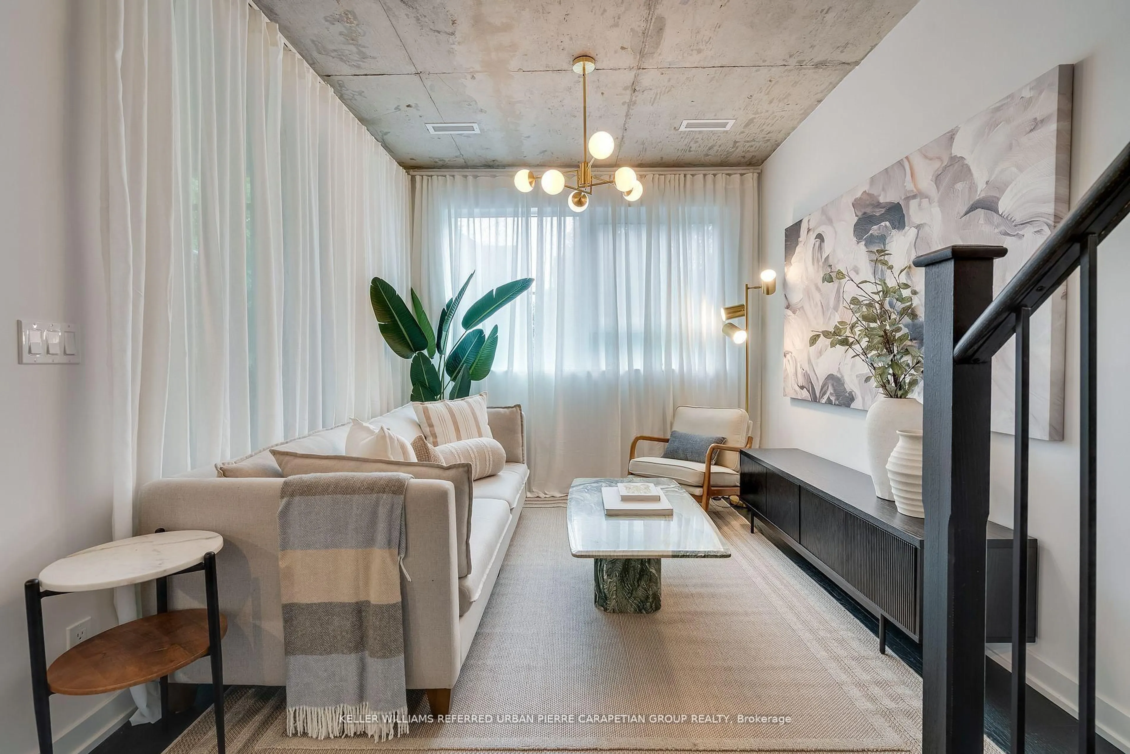 Living room with furniture, cement floor for 57 Brock Ave #TH 109, Toronto Ontario M6K 0H3