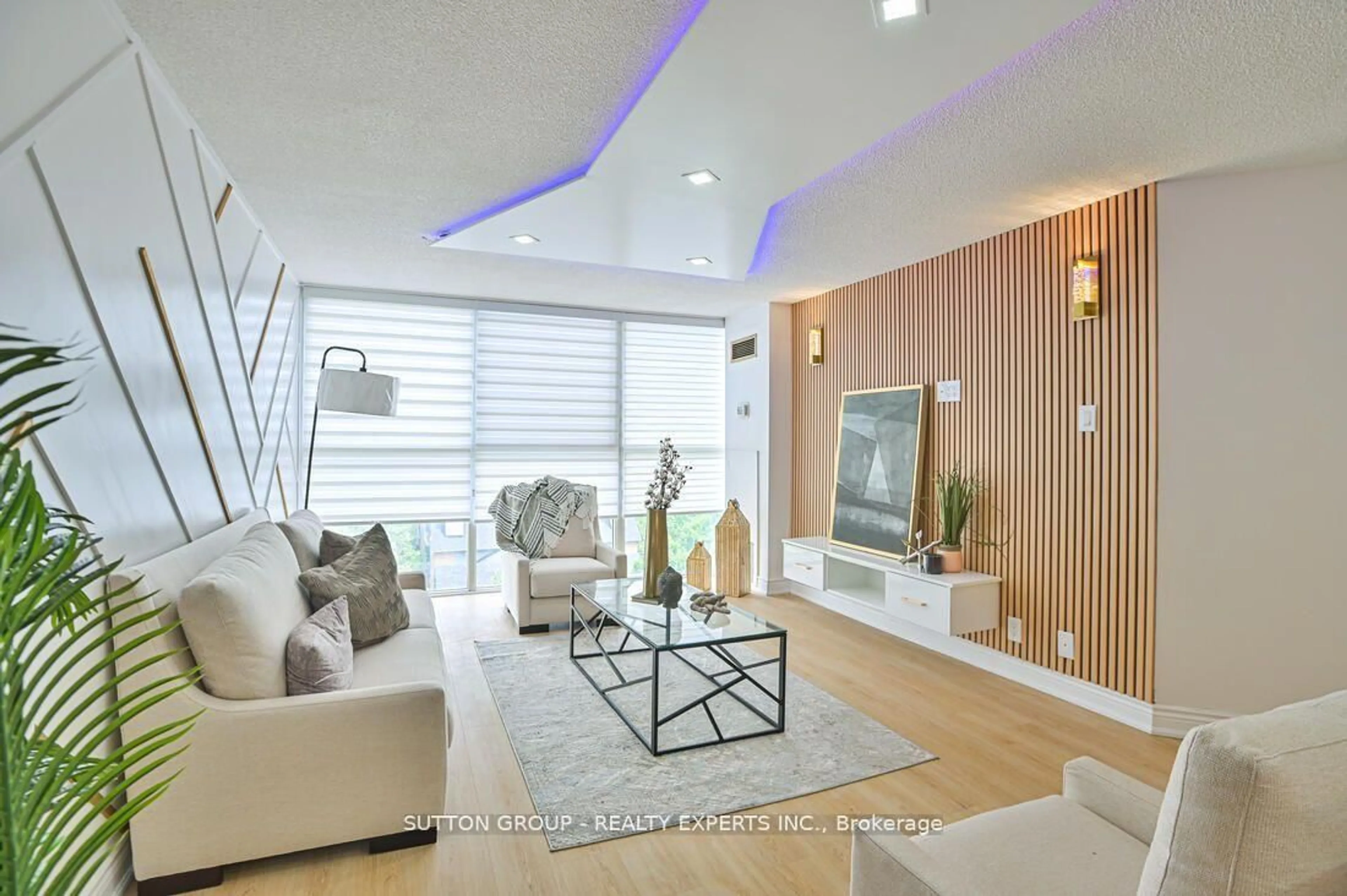 Living room with furniture, wood/laminate floor for 35 Trailwood Dr #713, Mississauga Ontario L4Z 3L6