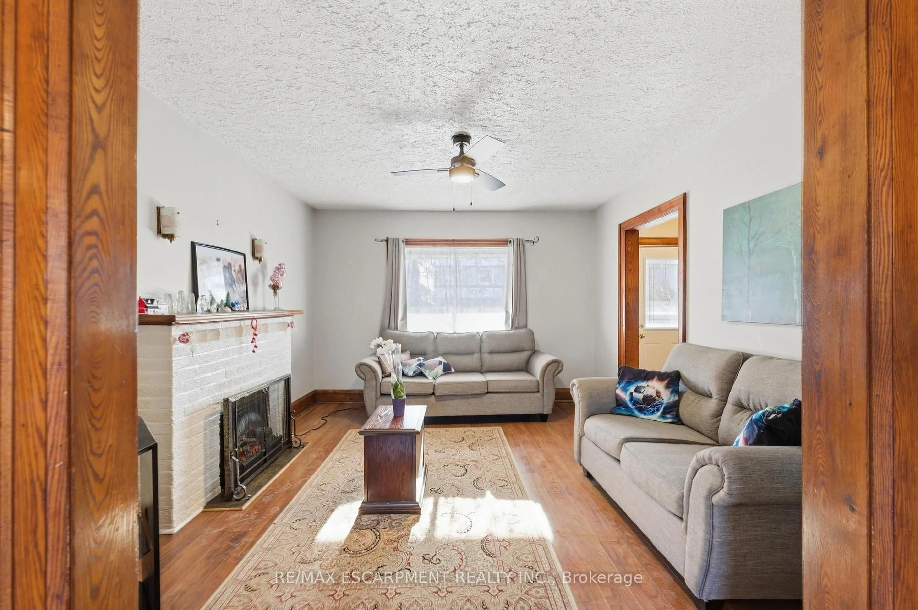 Living room with furniture, wood/laminate floor for 24 Mahoney Ave, Toronto Ontario M6M 2H4