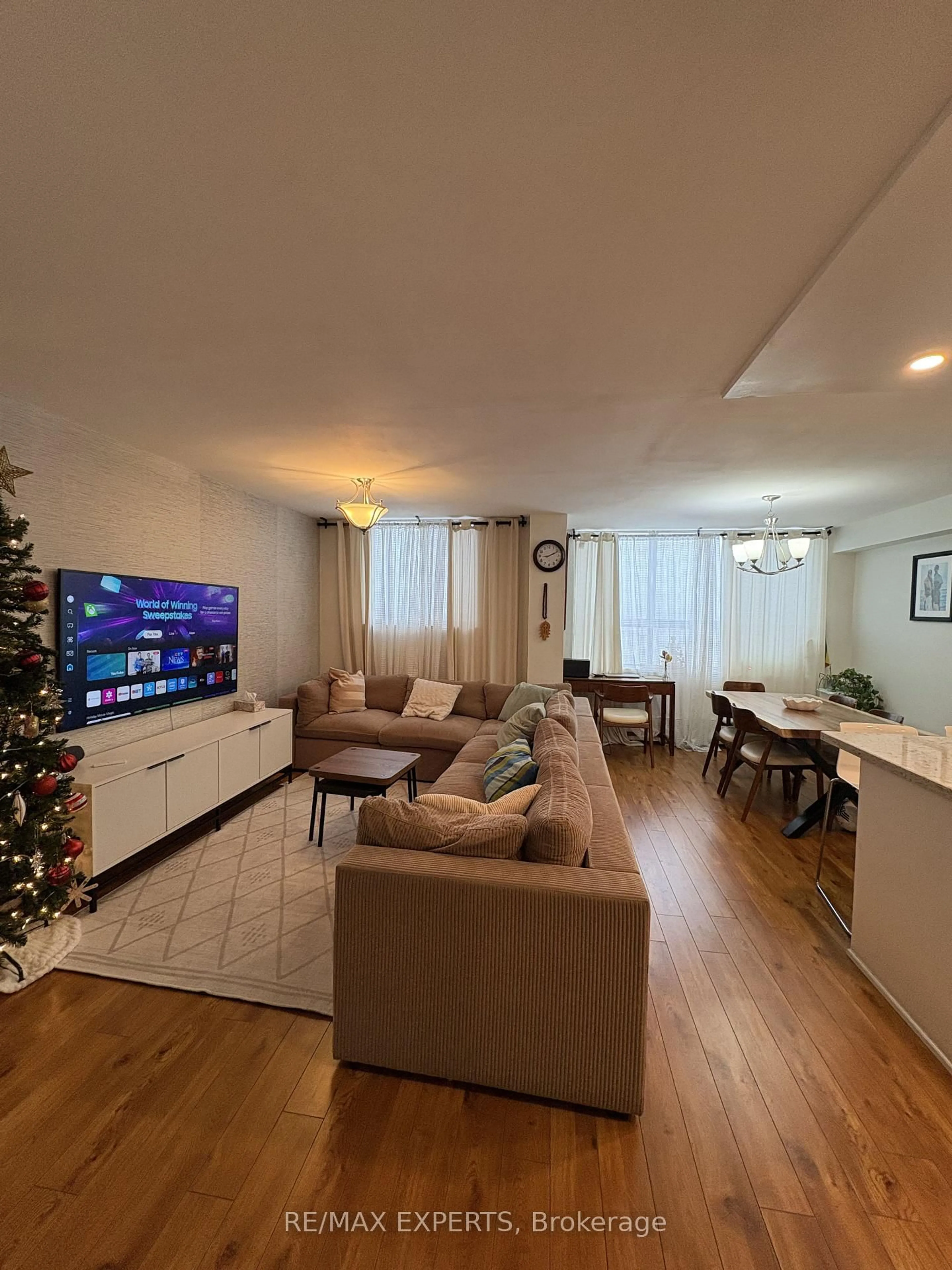 Living room with furniture, wood/laminate floor for 100 Lotherton Ptwy #1002, Toronto Ontario M6B 2G8