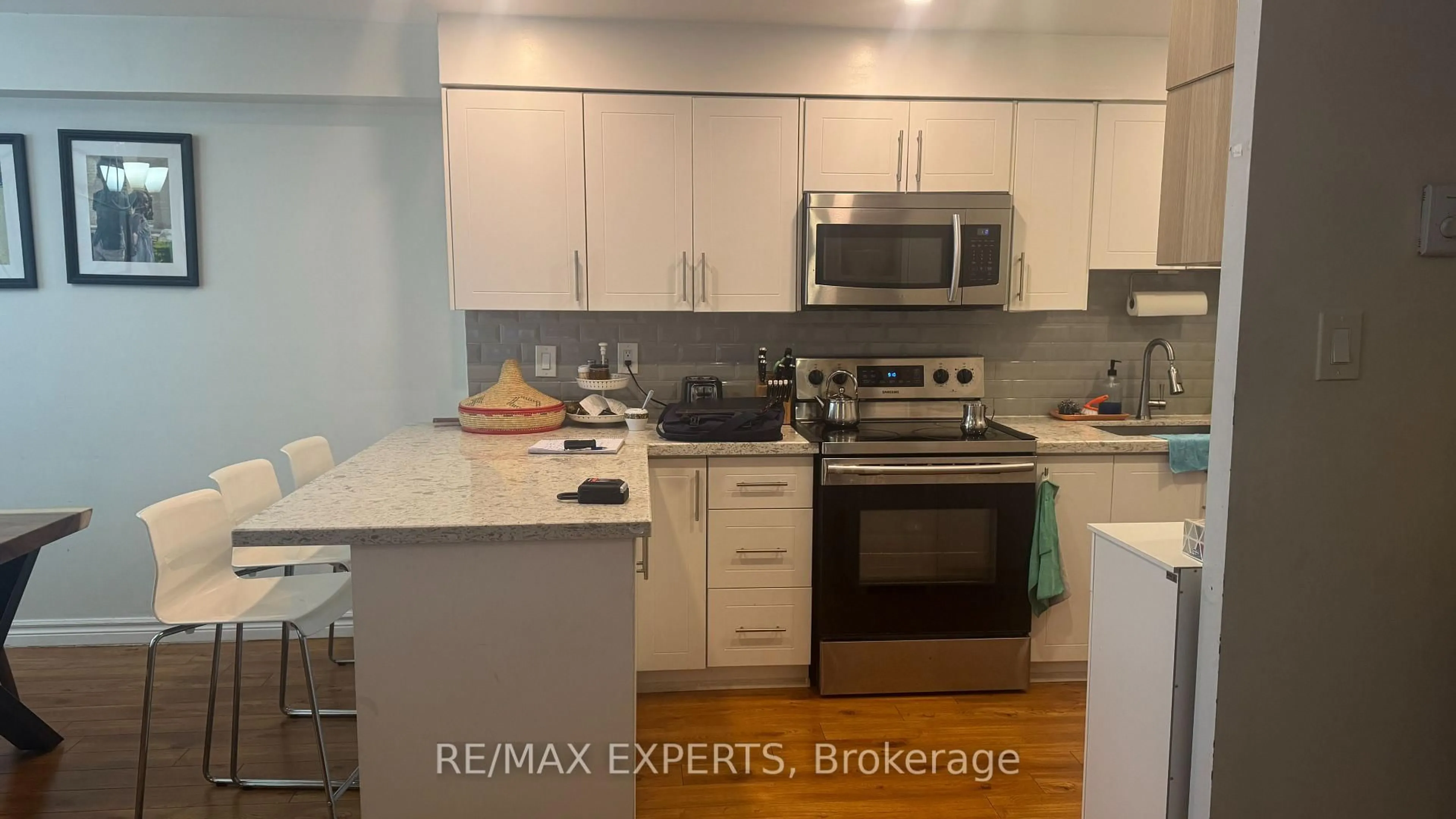 Open concept kitchen, wood/laminate floor for 100 Lotherton Ptwy #1002, Toronto Ontario M6B 2G8