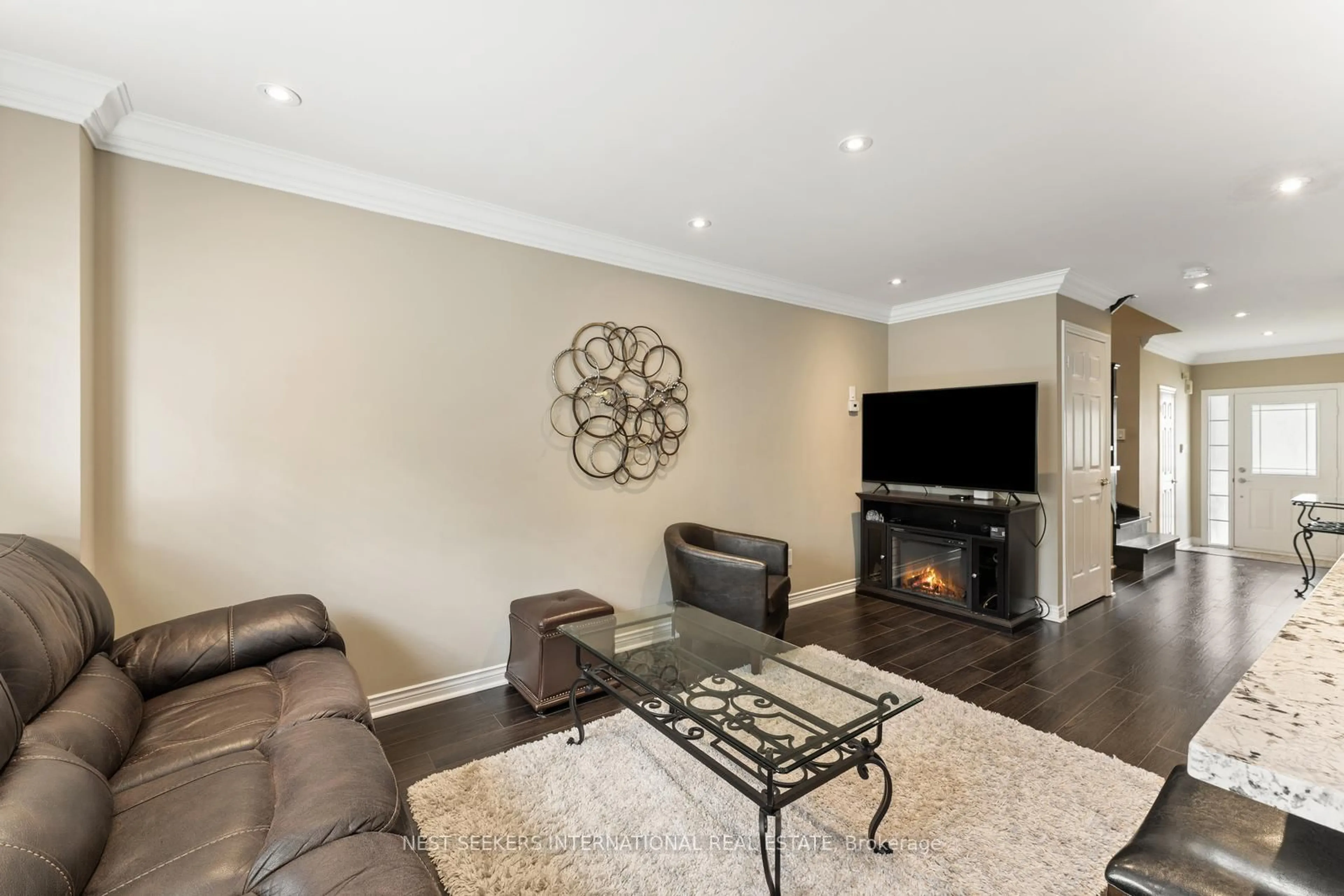 Living room with furniture, wood/laminate floor for 46 Waterbury St, Caledon Ontario L7E 1X4