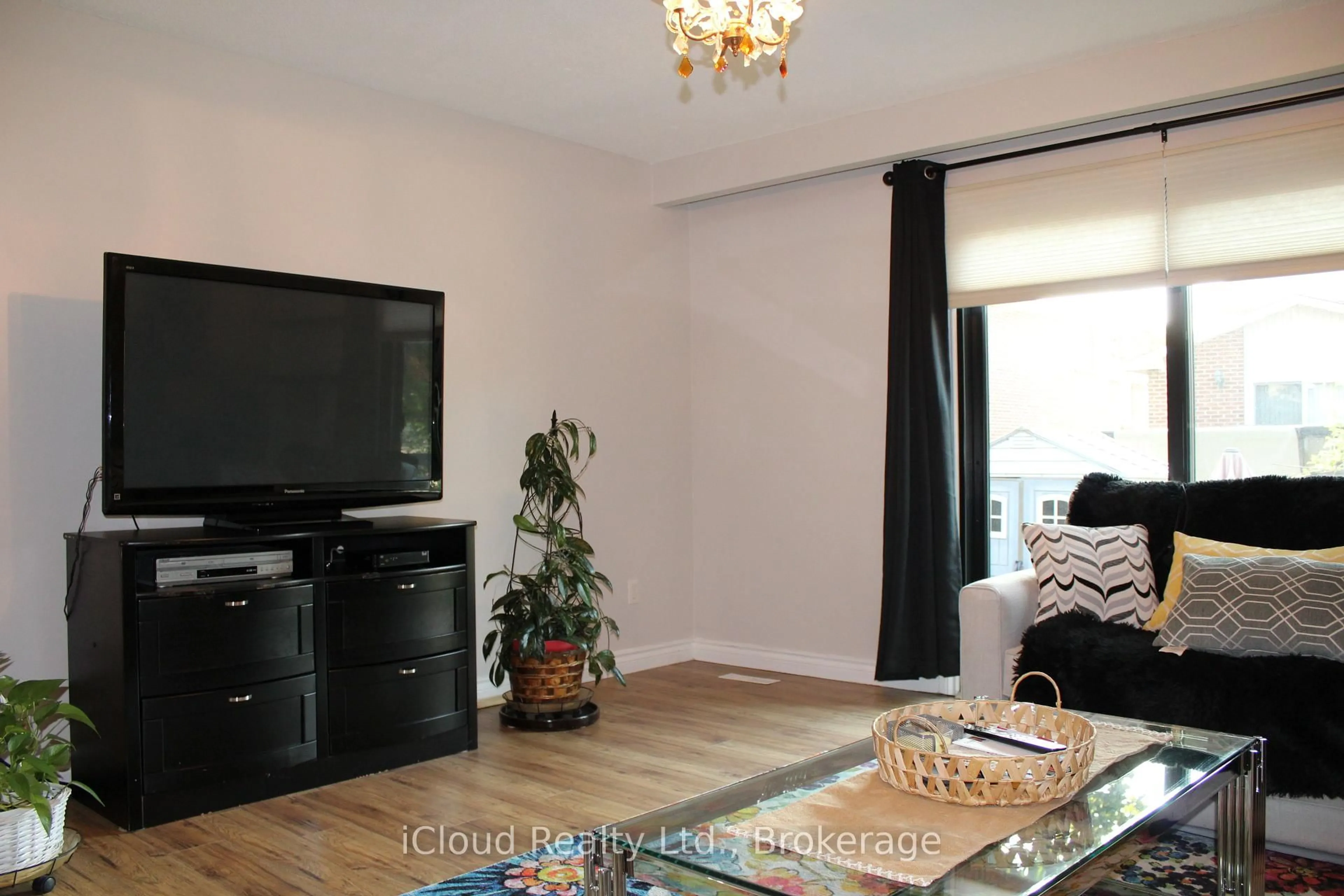 Living room with furniture, wood/laminate floor for 42 Lindridge Ave, Brampton Ontario L6S 3X1