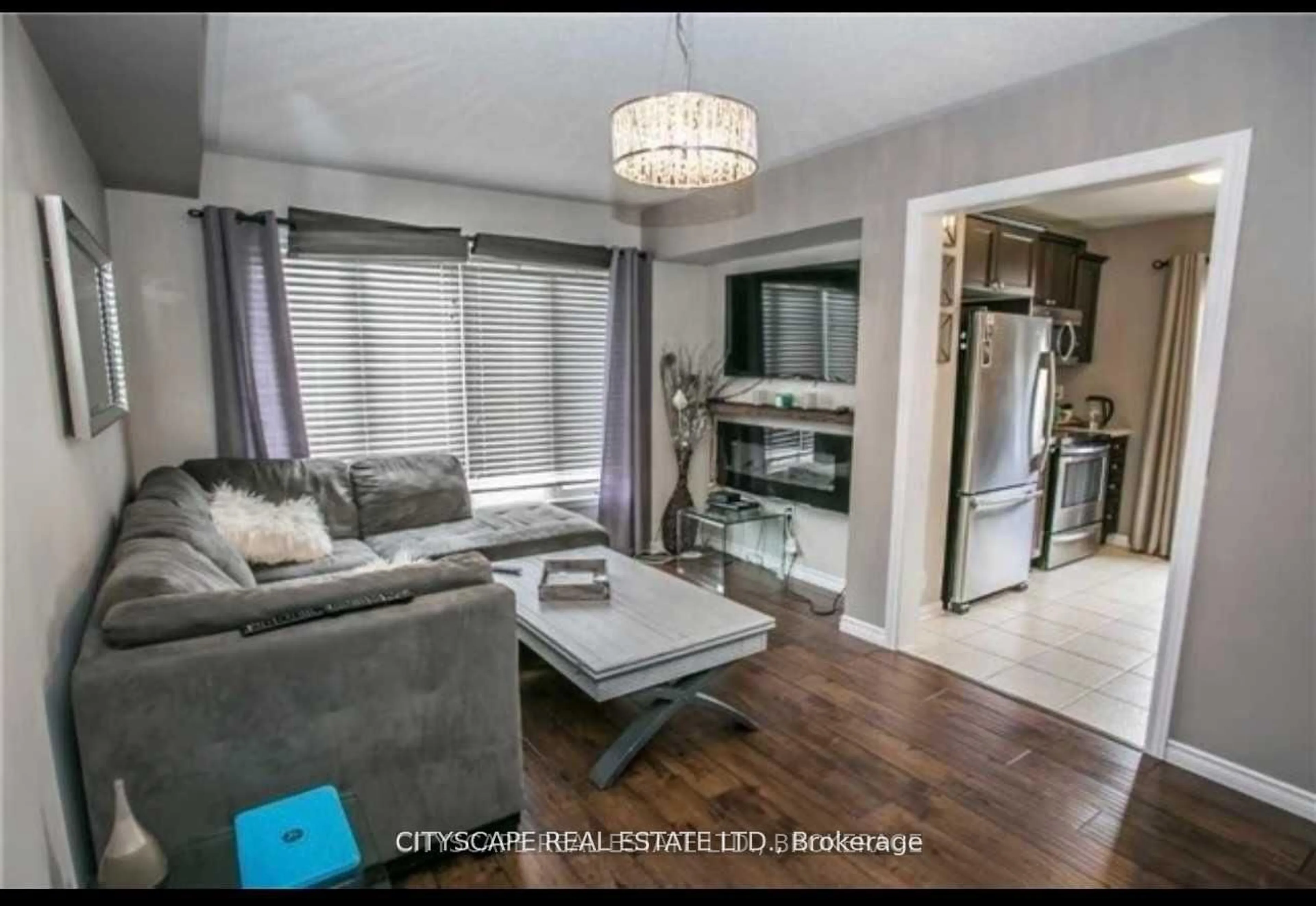 Living room with furniture, wood/laminate floor for 1023 Stemman Pl, Milton Ontario L9T 8R1