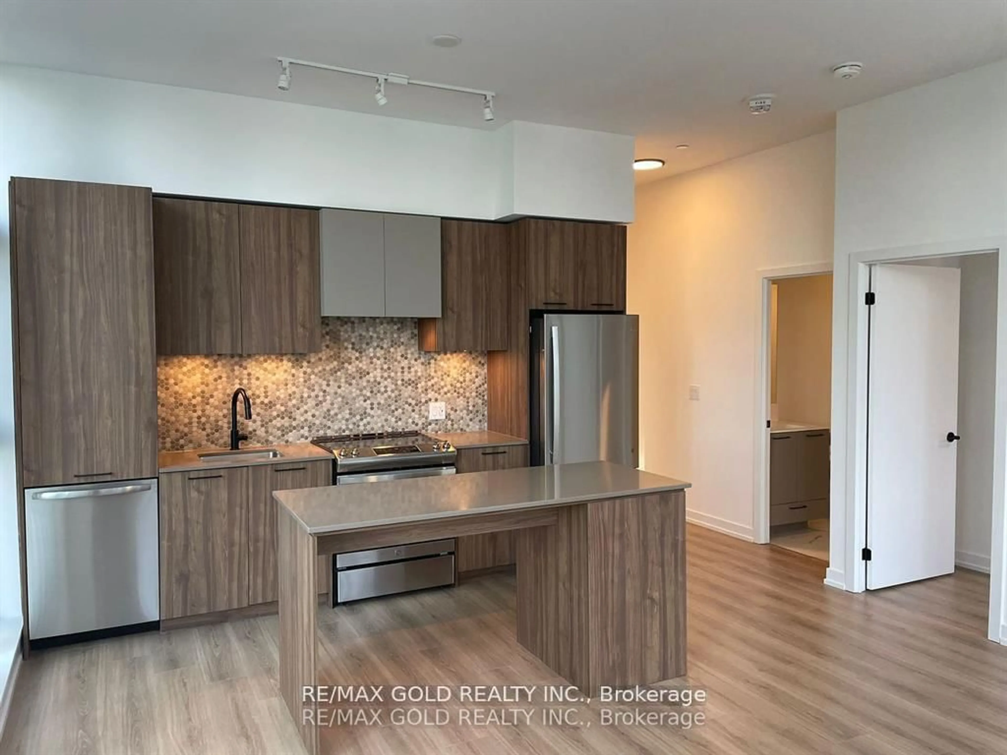 Open concept kitchen, wood/laminate floor for 10 Lagerfeld Dr #104, Brampton Ontario L7A 5L3