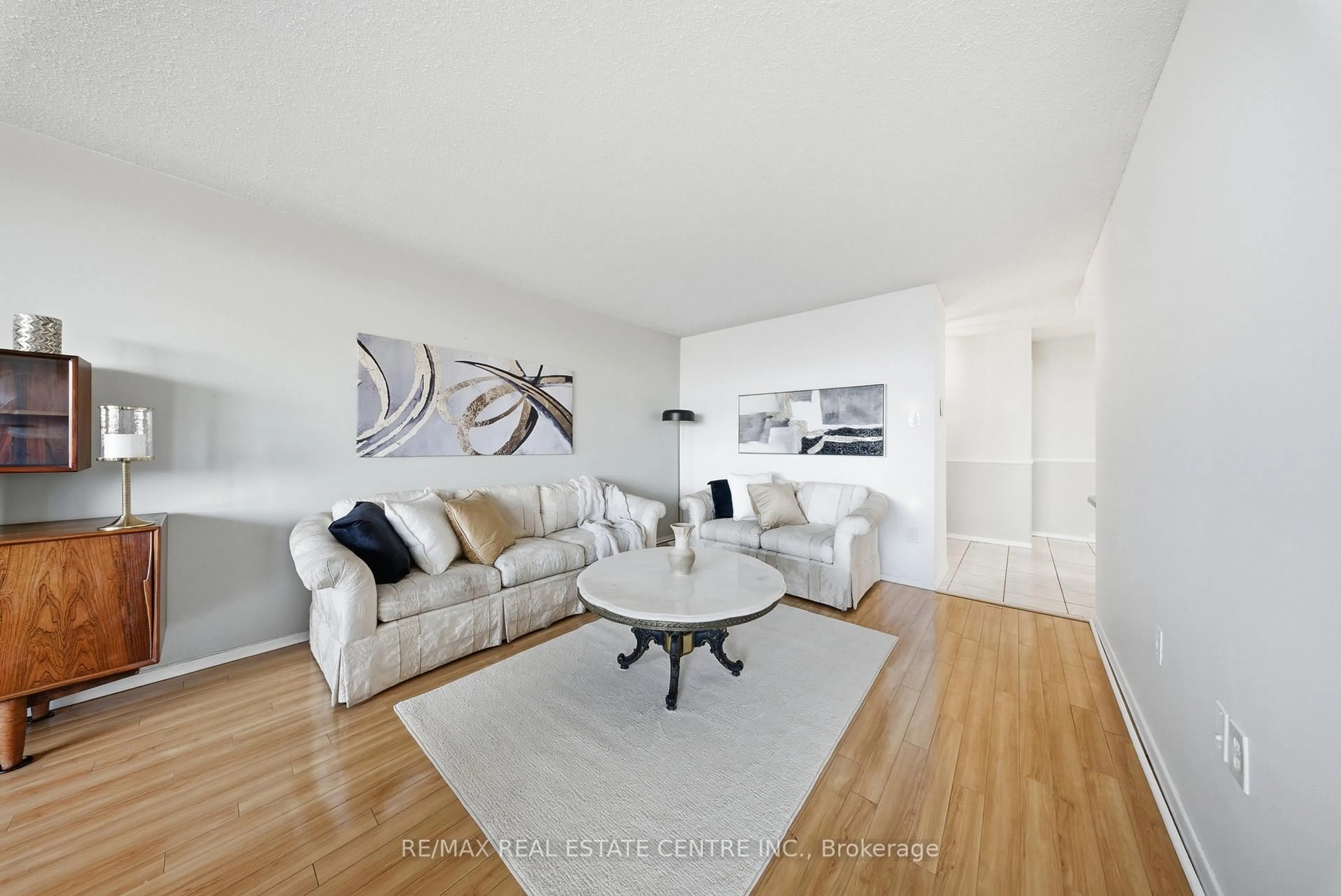 Living room with furniture, wood/laminate floor for 2055 Upper Middle Rd #602, Burlington Ontario L7P 3P4