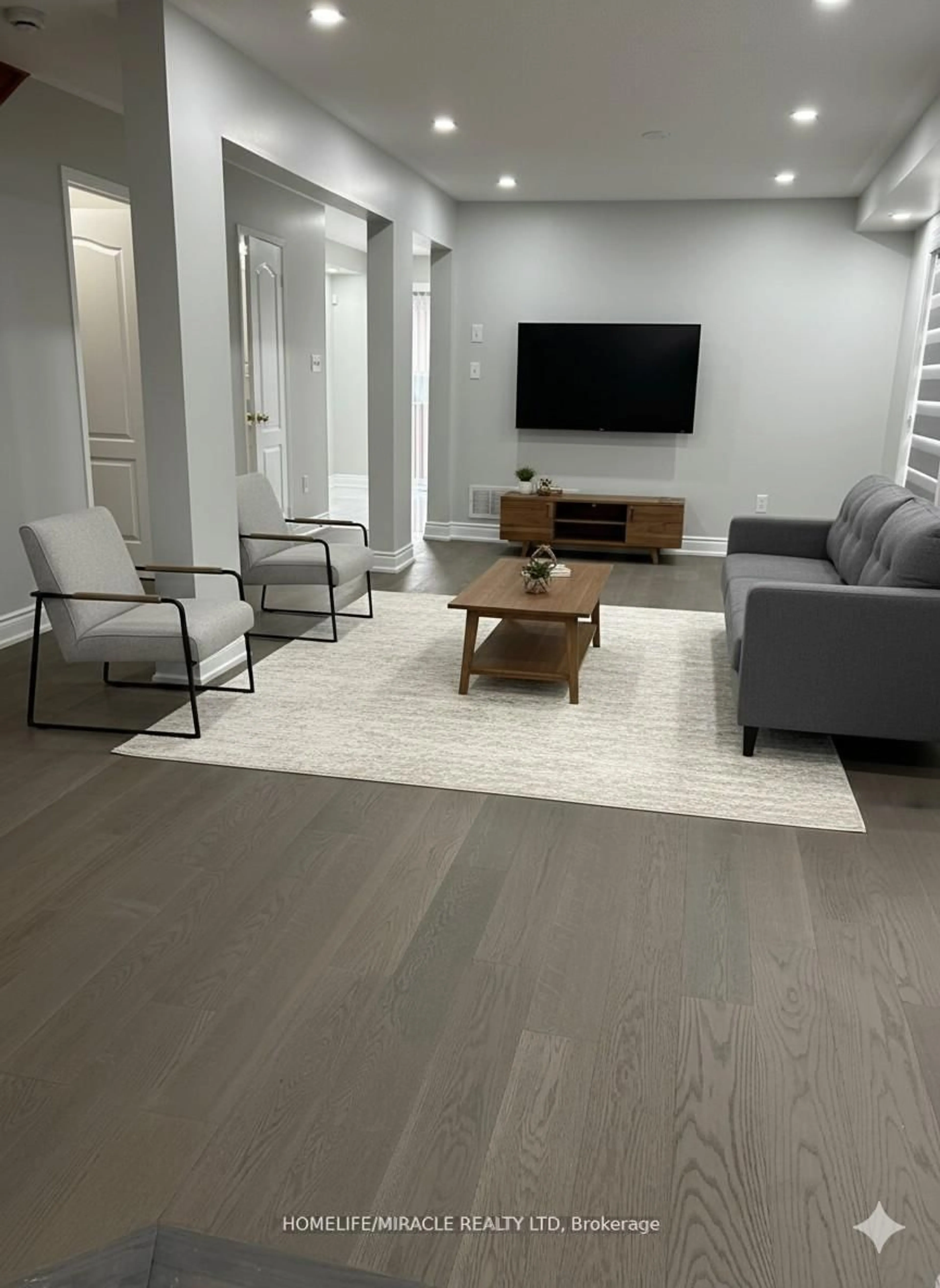 Living room with furniture, wood/laminate floor for 66 Studebaker Tr, Brampton Ontario L7A 3A5