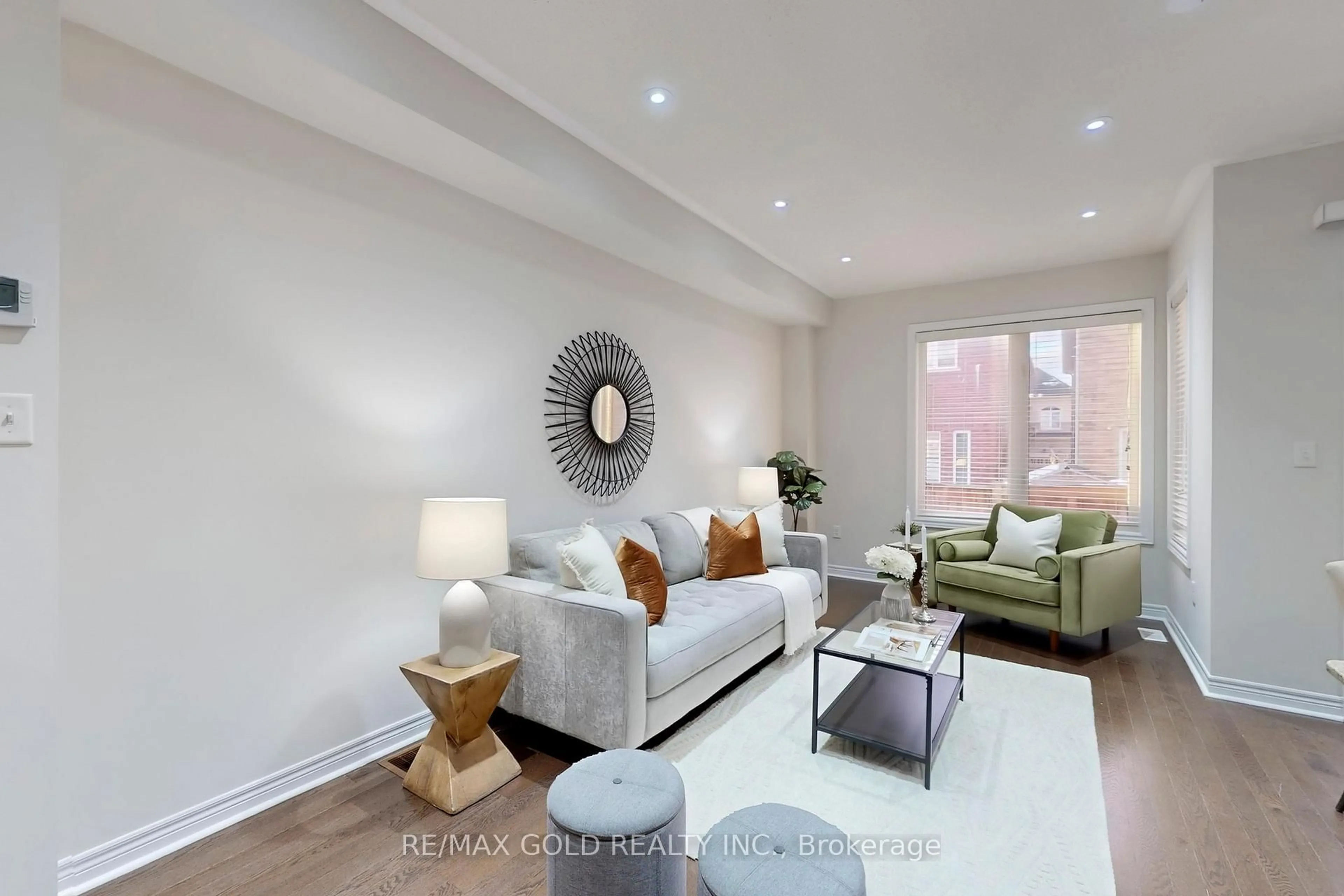 Living room with furniture, wood/laminate floor for 62 Pennycross Cres, Brampton Ontario L7A 4M1