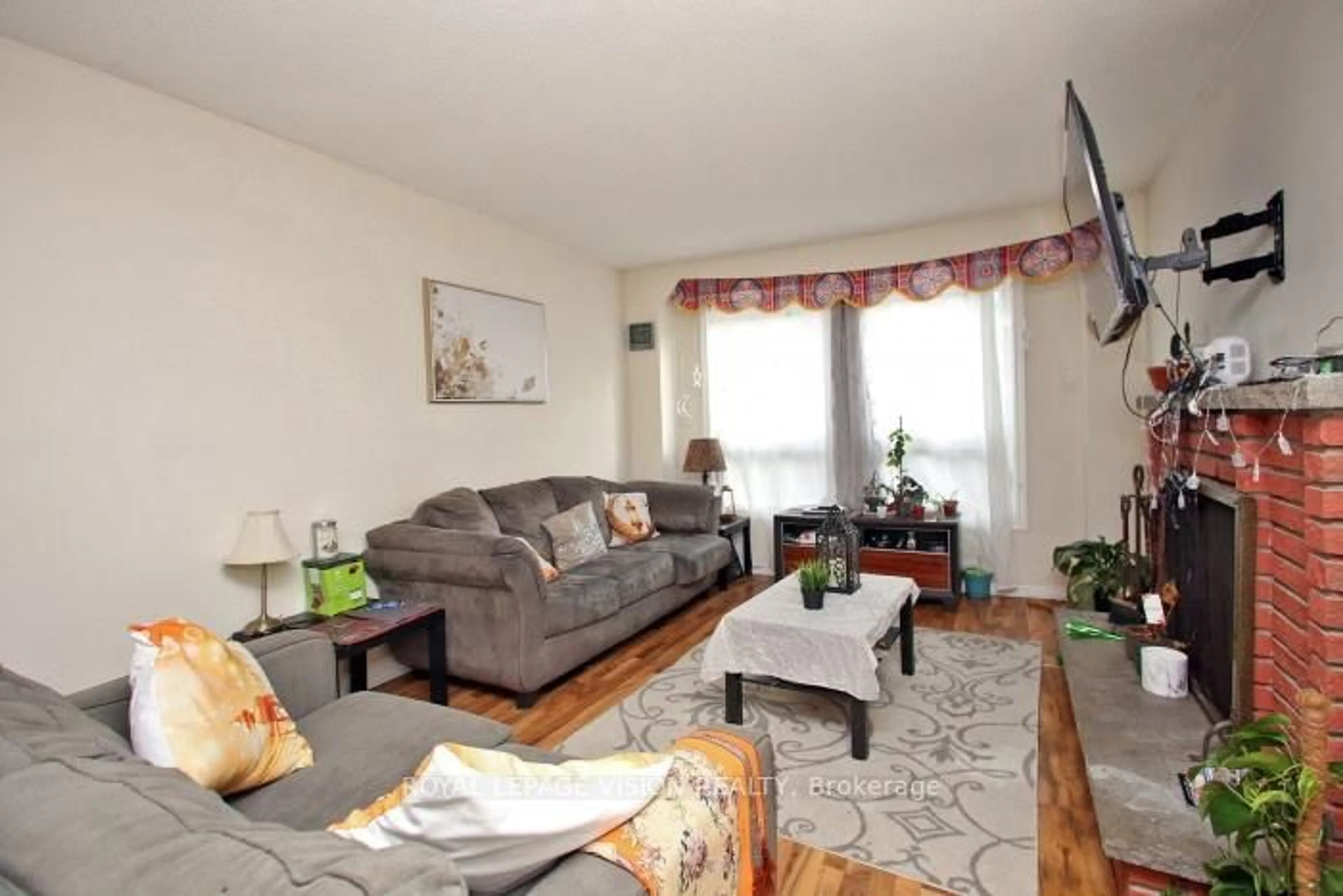 Living room with furniture, wood/laminate floor for 7080 Copenhagen Rd #64, Mississauga Ontario L5N 2C9