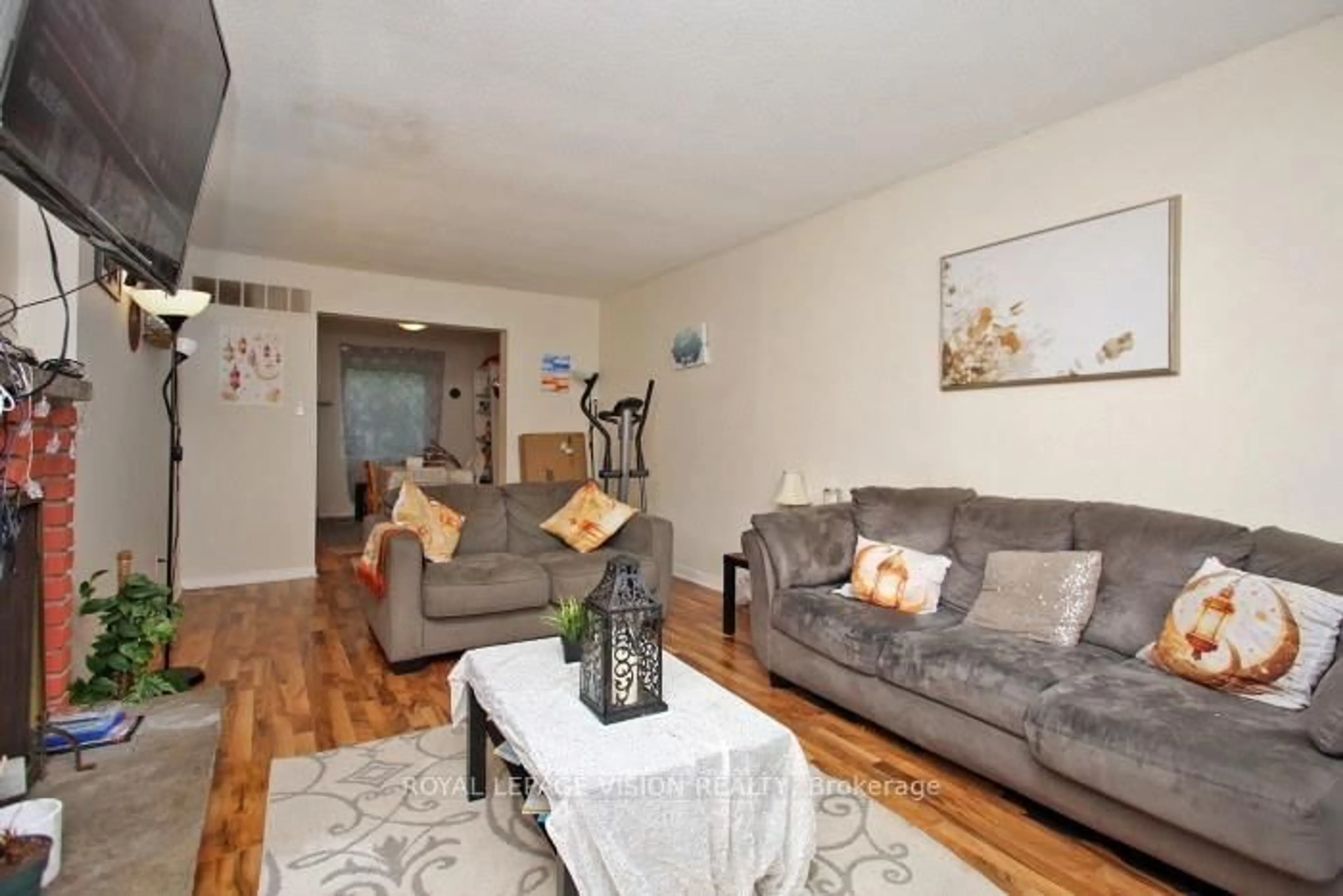 Living room with furniture, wood/laminate floor for 7080 Copenhagen Rd #64, Mississauga Ontario L5N 2C9