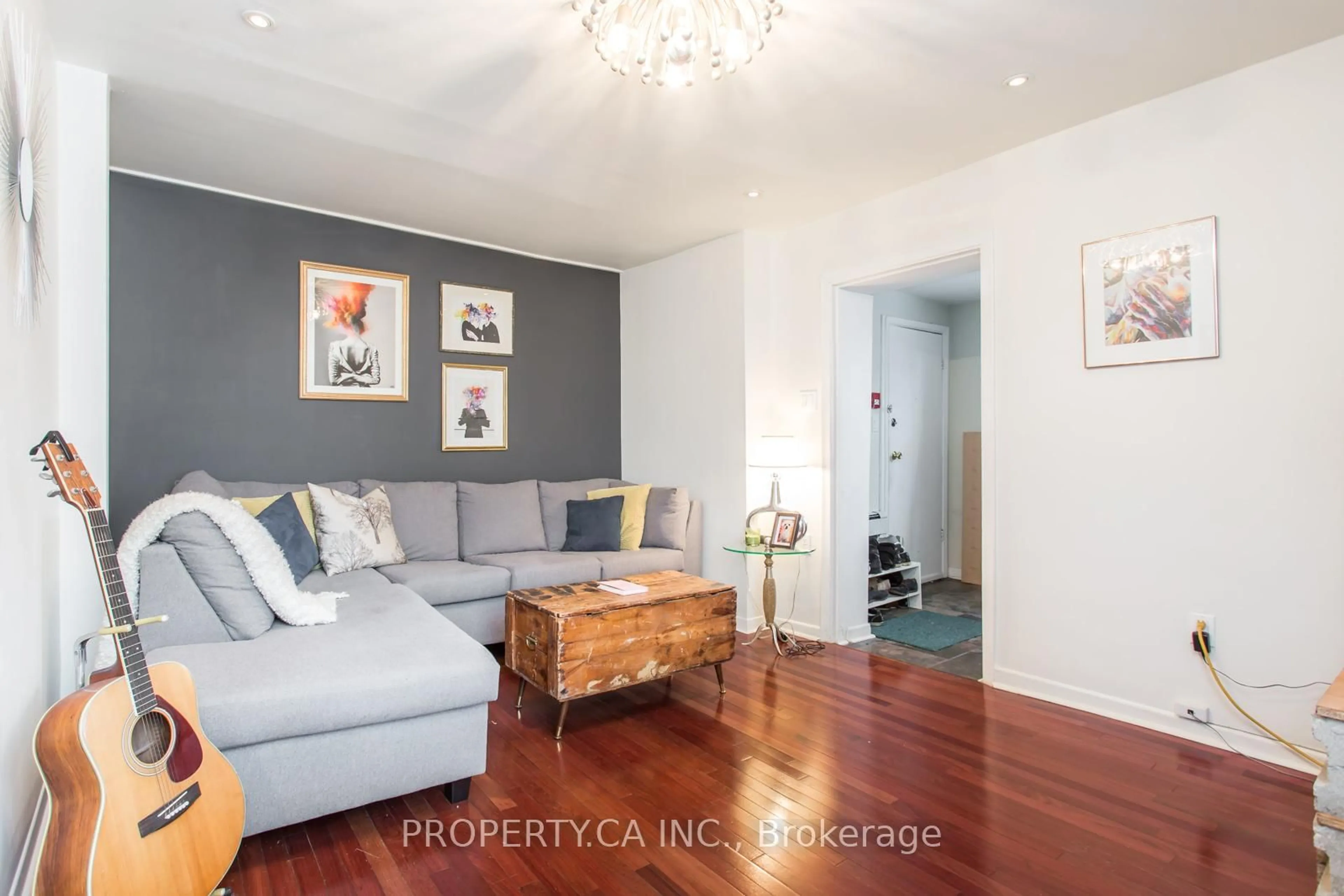 Living room with furniture, wood/laminate floor for 22 Brad St, Toronto Ontario M6P 1N1