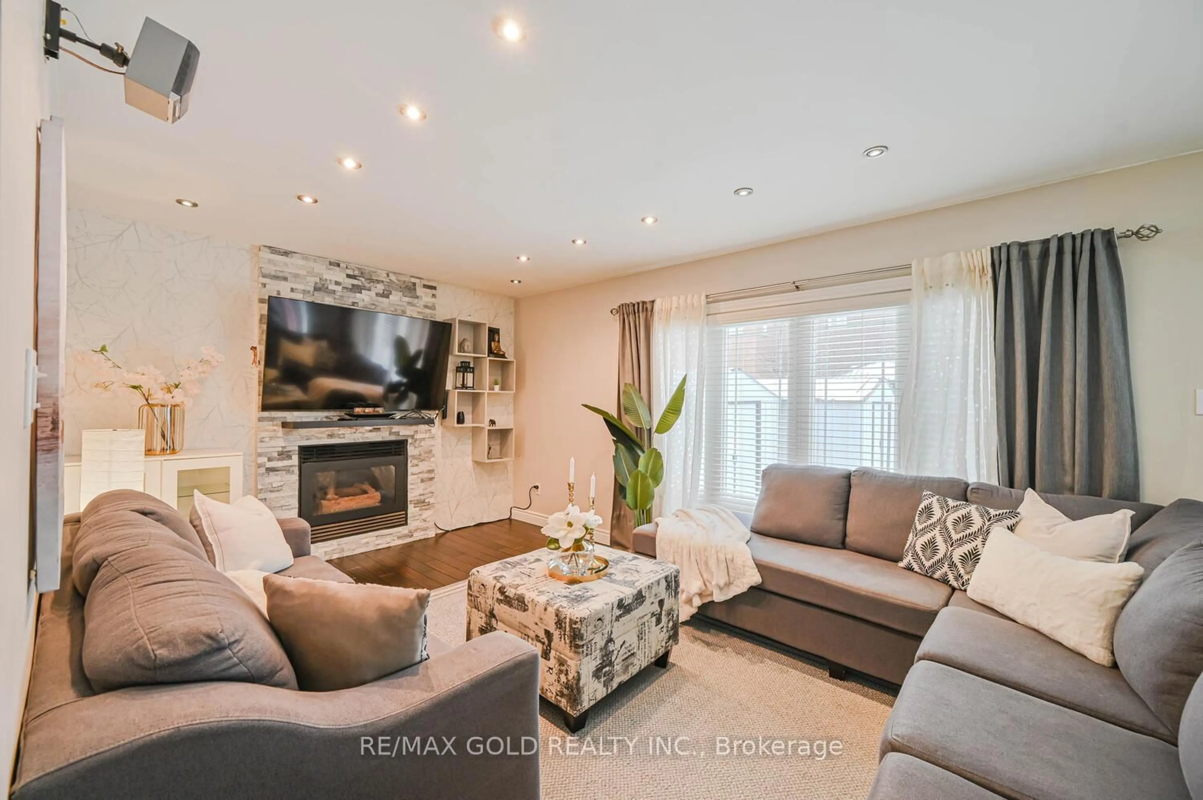 Living room with furniture, wood/laminate floor for 30 Foxtail Rd, Brampton Ontario L6R 1E2