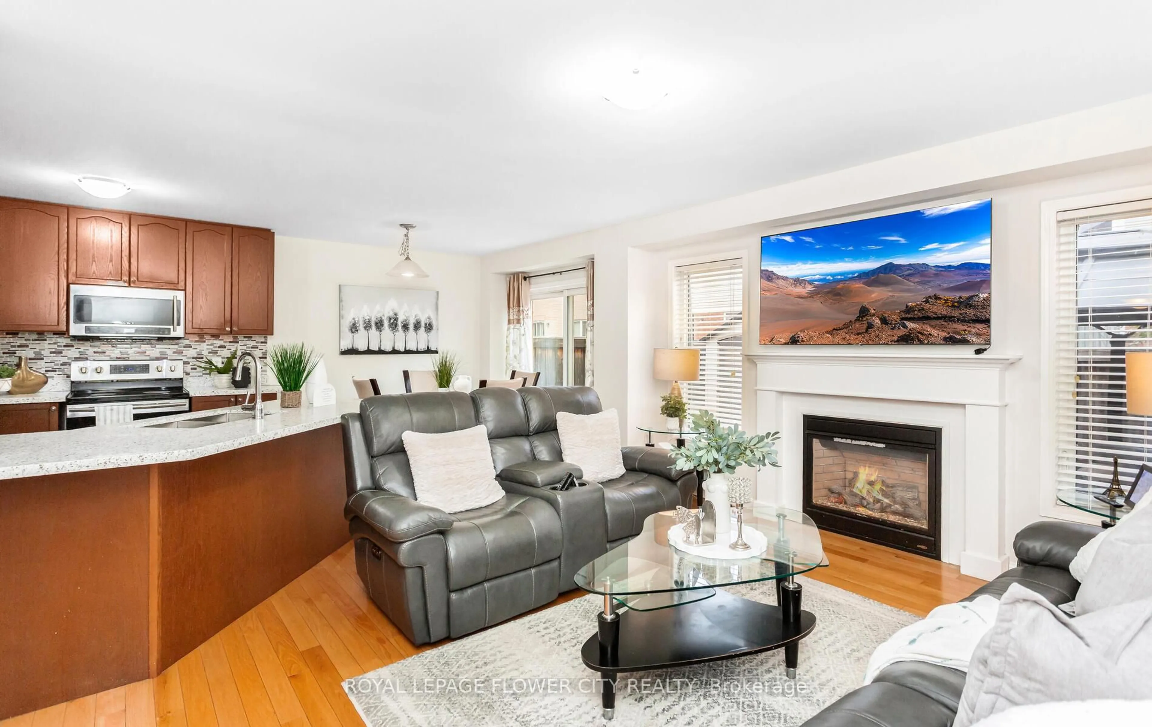 Living room with furniture, wood/laminate floor for 47 Haverty Tr, Brampton Ontario L7A 0S3