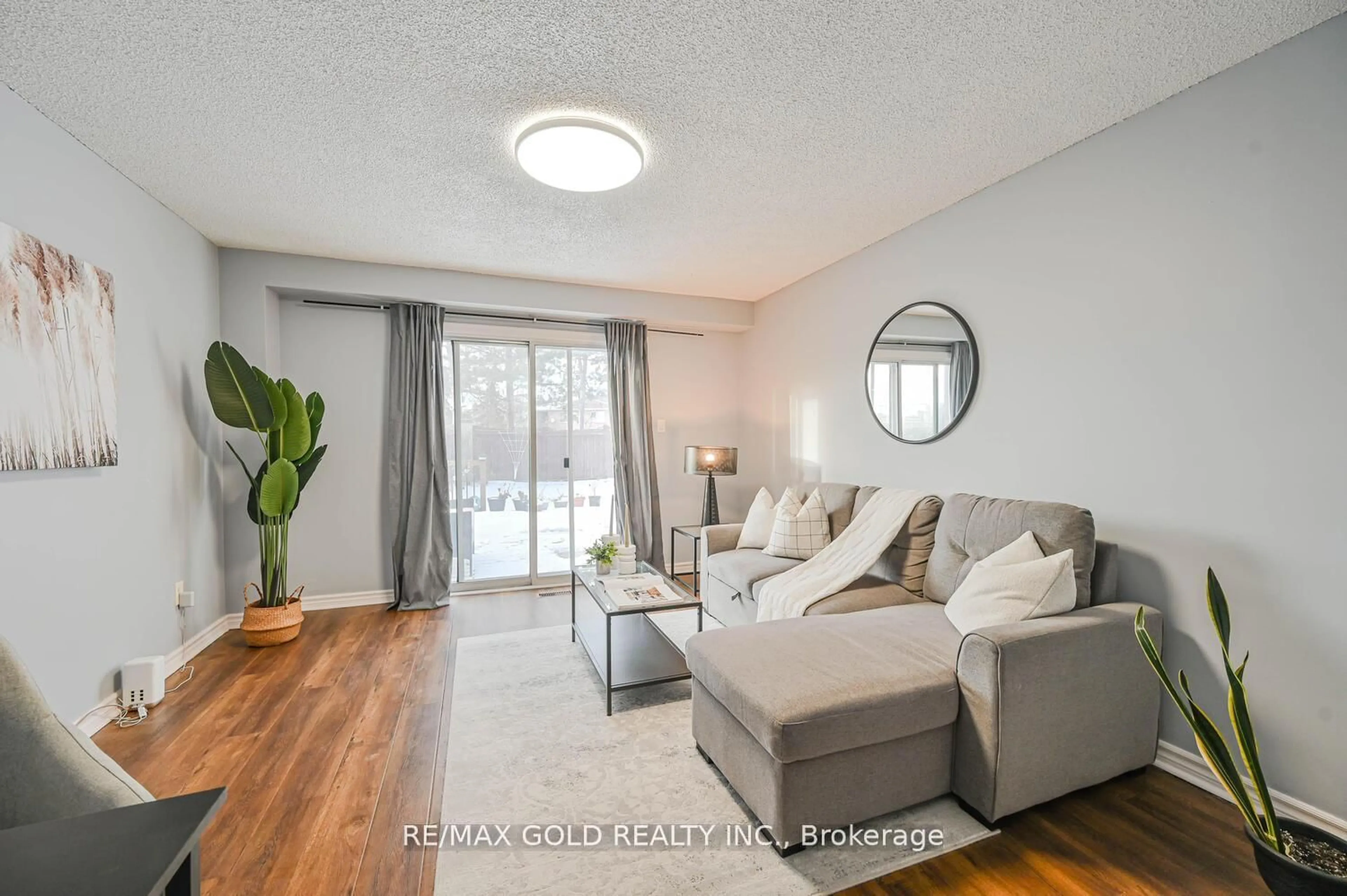 Living room with furniture, wood/laminate floor for 73 Chipmunk Cres, Brampton Ontario L6R 1B4